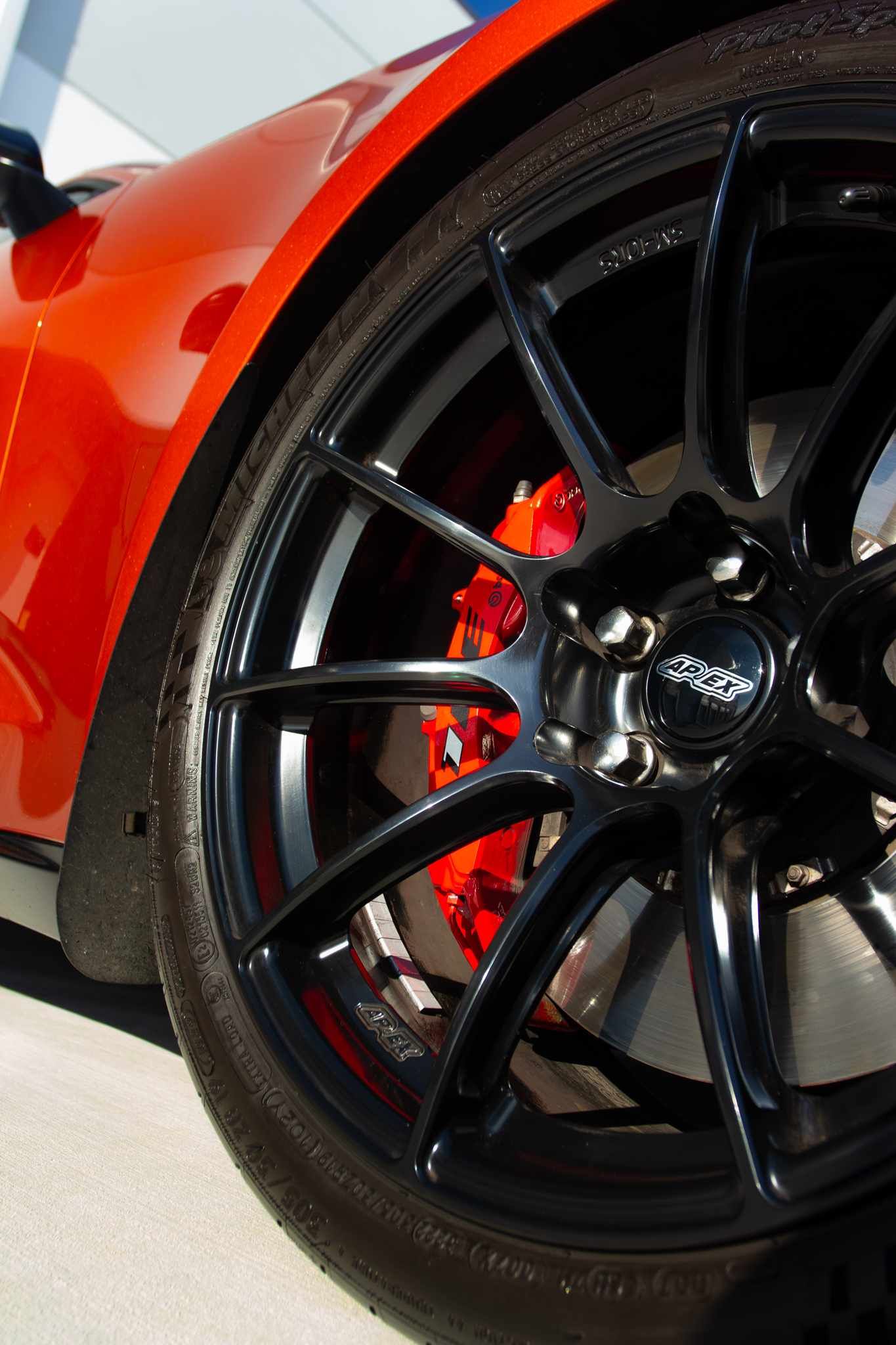 Red Chevrolet 6th Gen Camaro ZL1 1LE with 19" SM-10RS Apex wheels in Satin Black