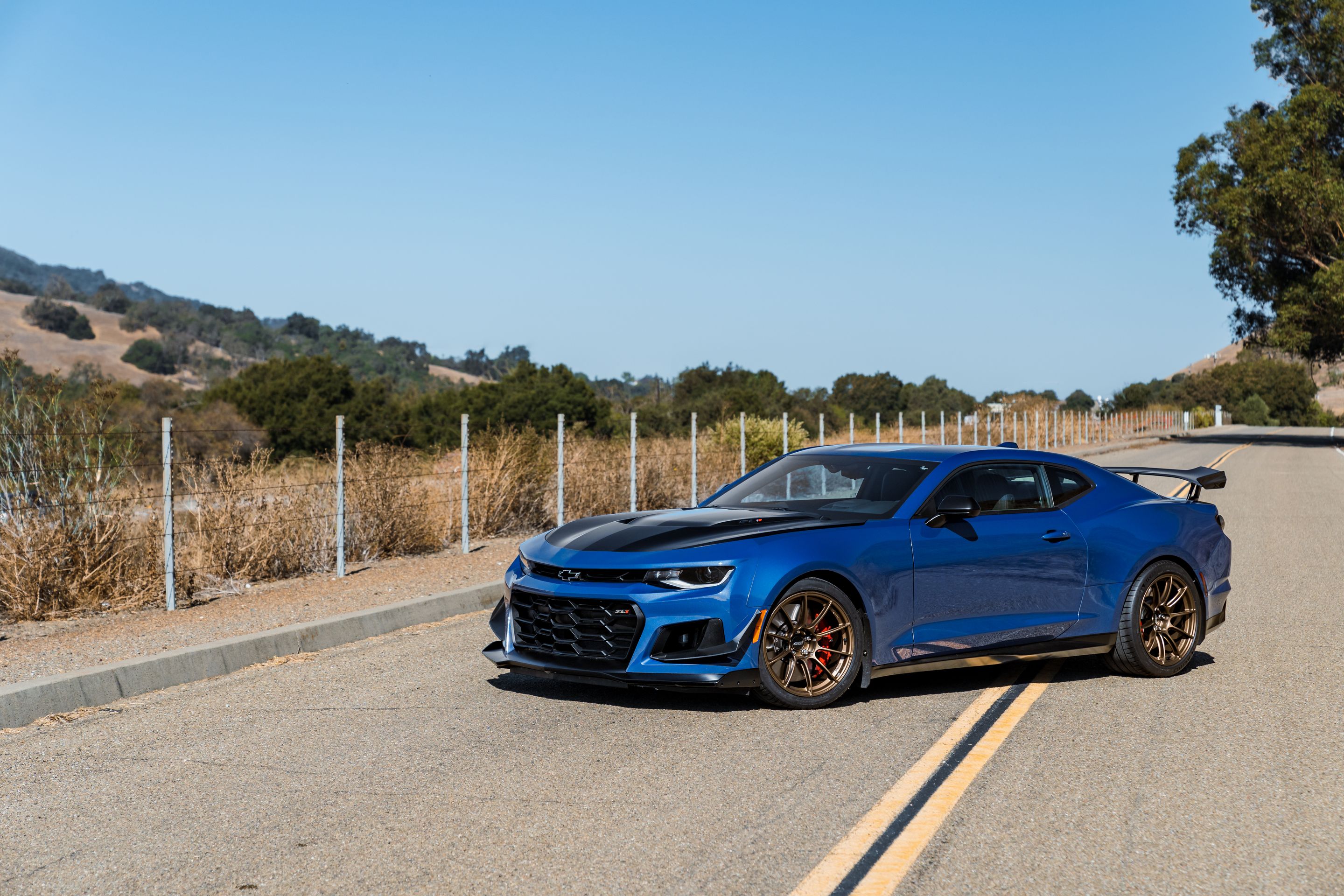 Blue Chevrolet 6th Gen Camaro ZL1 1LE with 19" SM-10RS Apex wheels in Satin Bronze