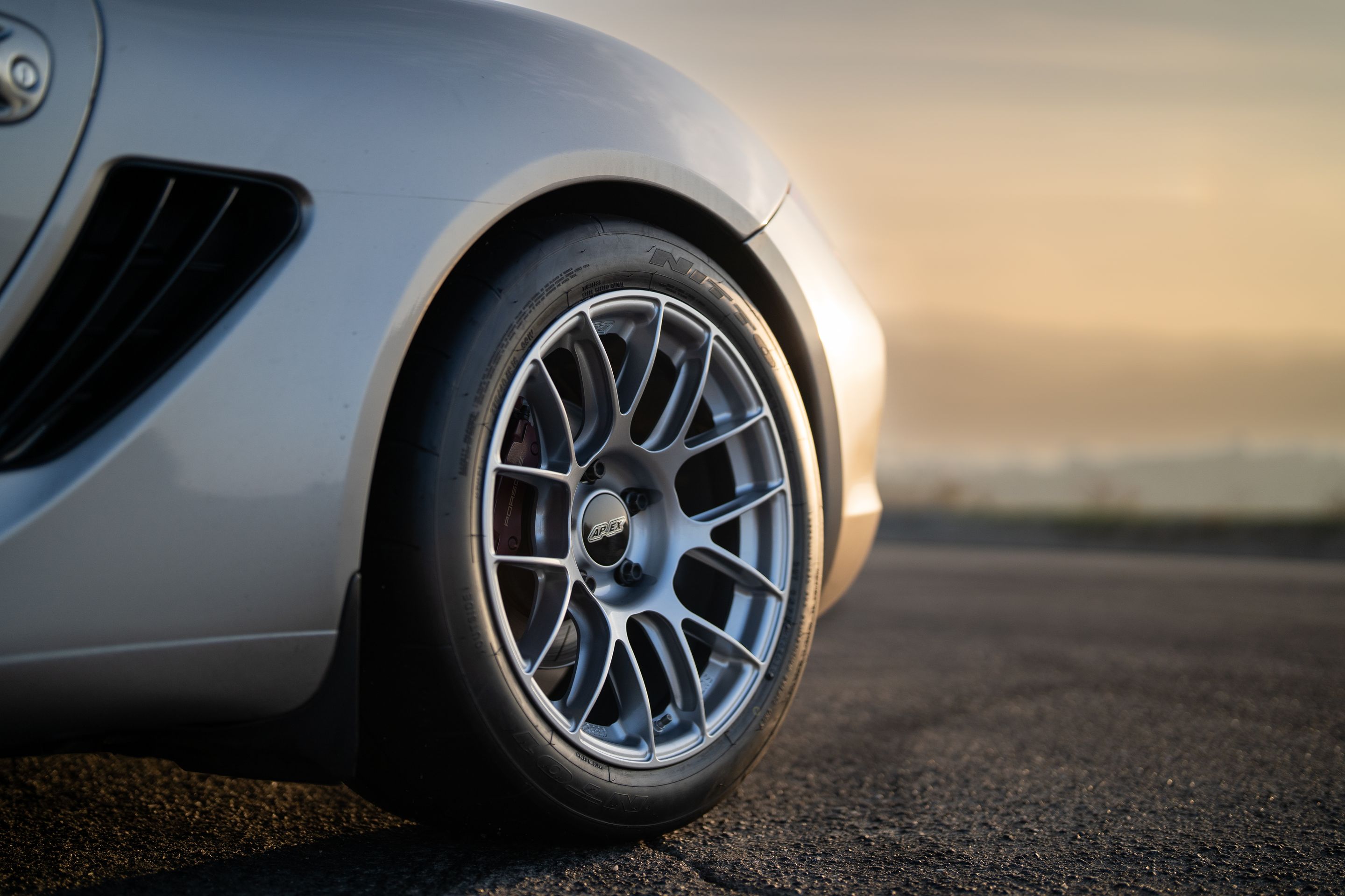 Grey Porsche 987 Cayman R with 18" EC-7RS Apex wheels in Race Silver