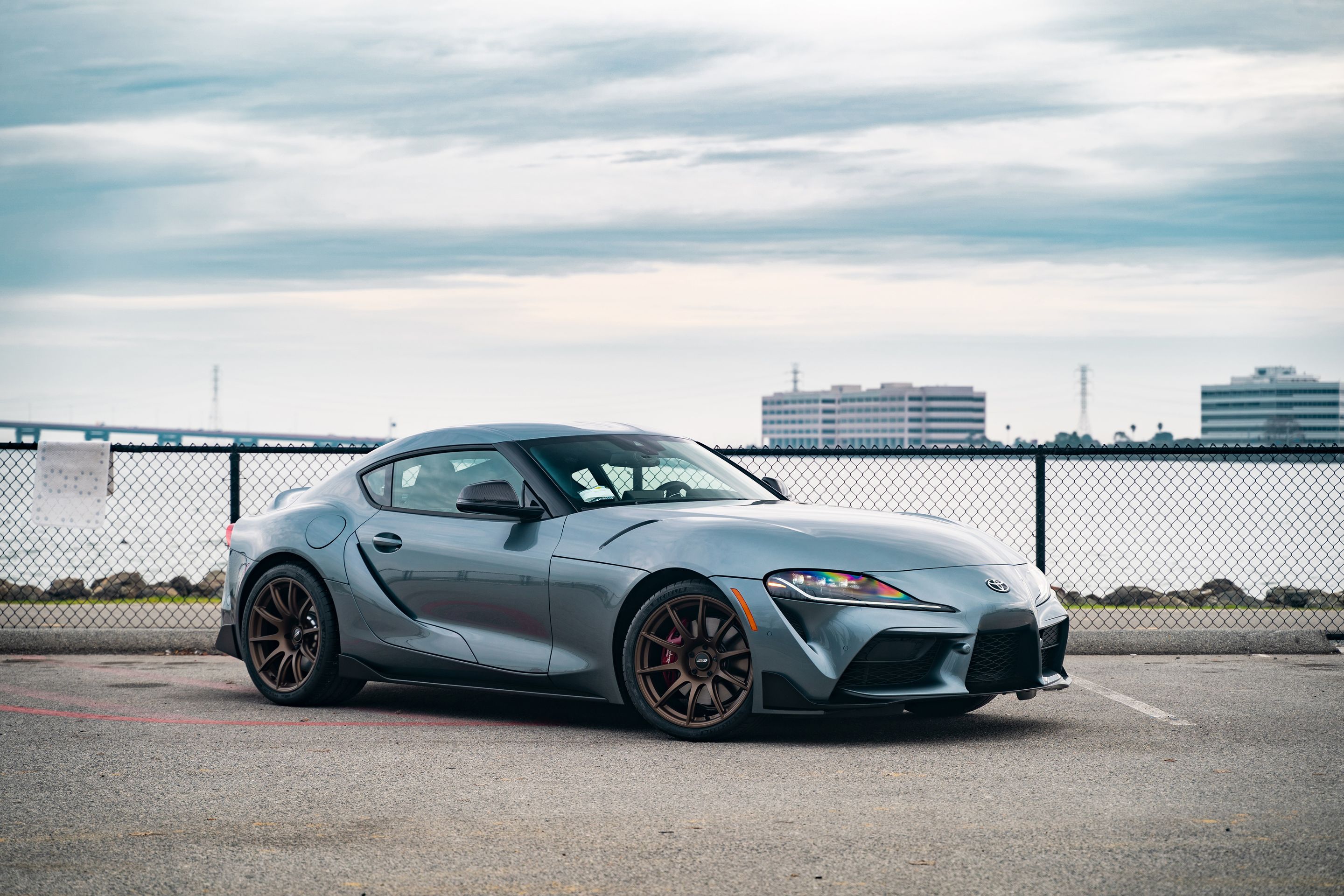 Grey Toyota GR Supra with 19" SM-10 Apex wheels in Satin Bronze