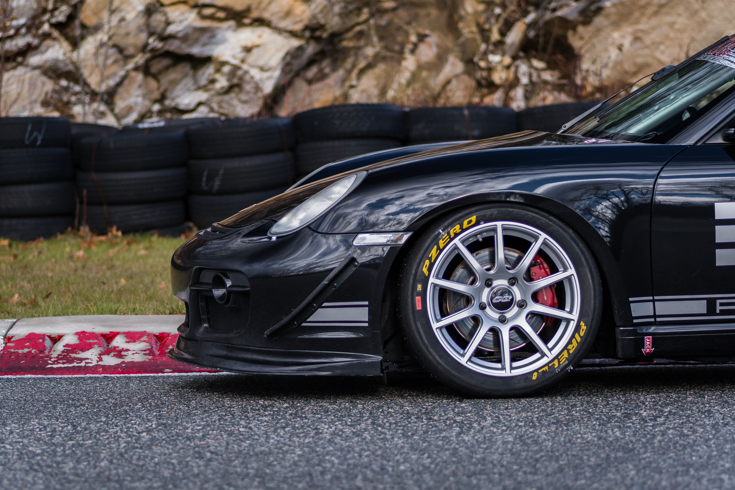 Black Porsche 987 Cayman S with 18" SM-10 Apex wheels in Race Silver