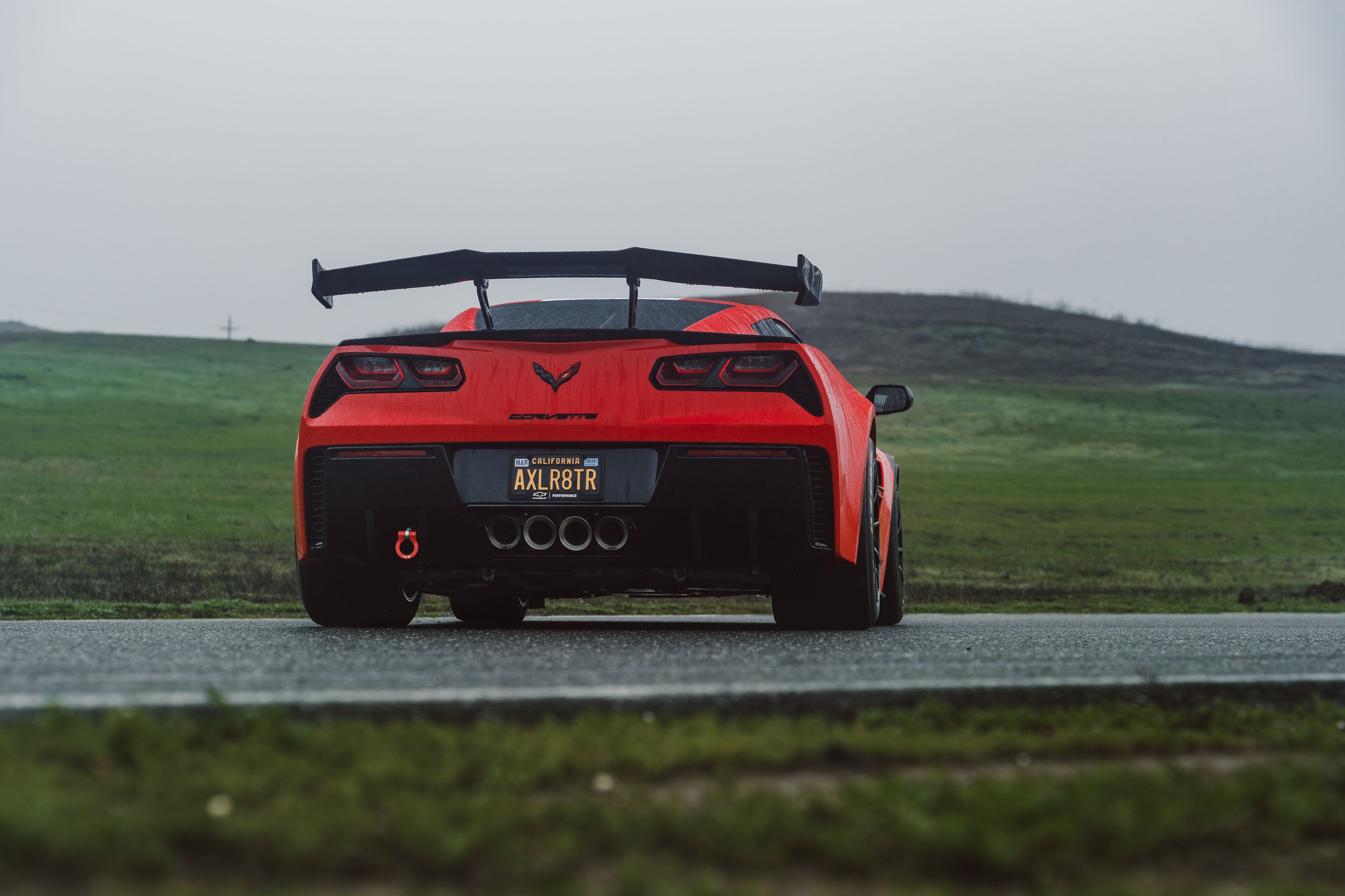 Red Chevrolet C7 Corvette Grand Sport with 18" SM-10RE Apex wheels in Satin Black