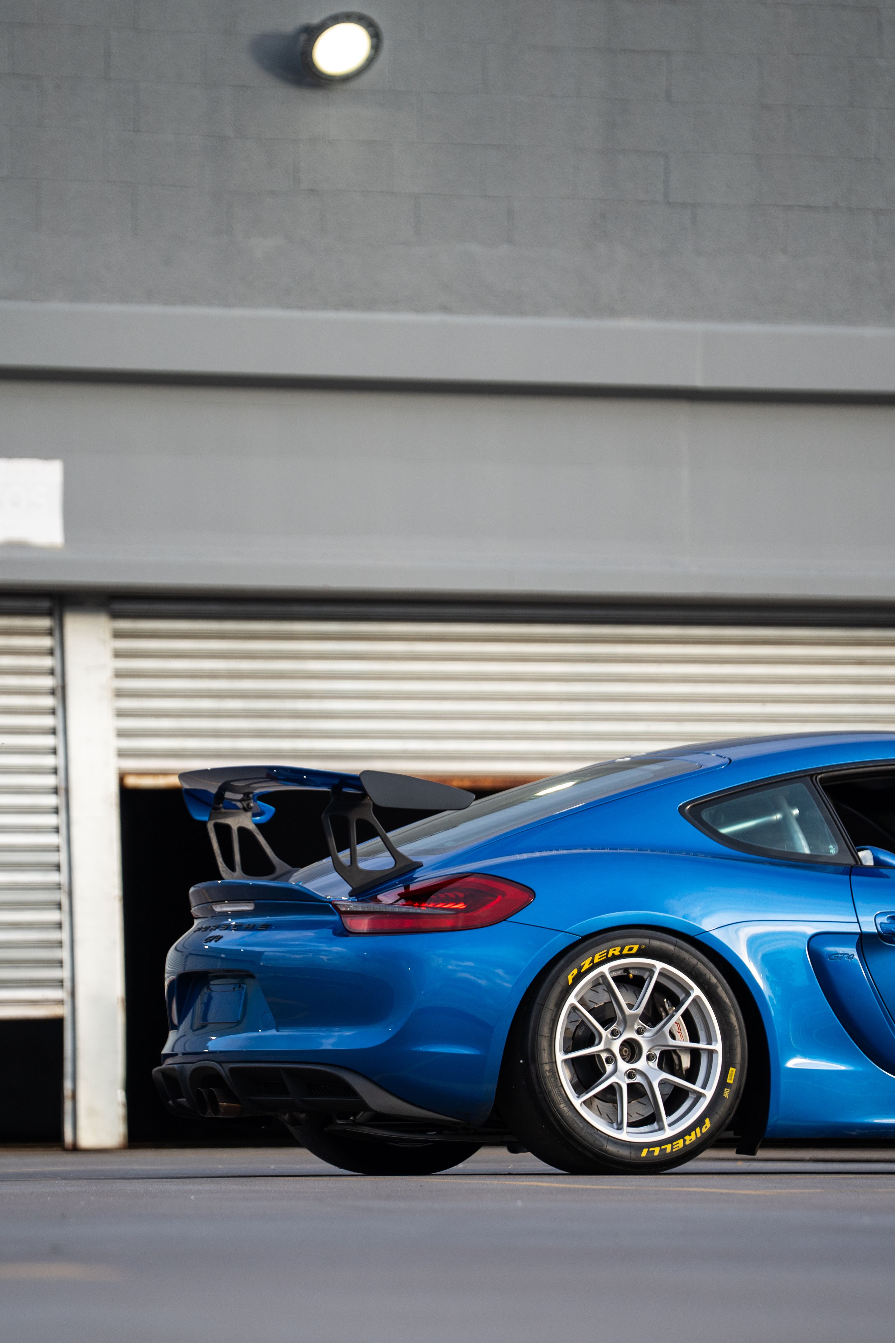 Blue Porsche 981 Cayman GT4 with 18" VS-5RE Apex wheels in Race Silver