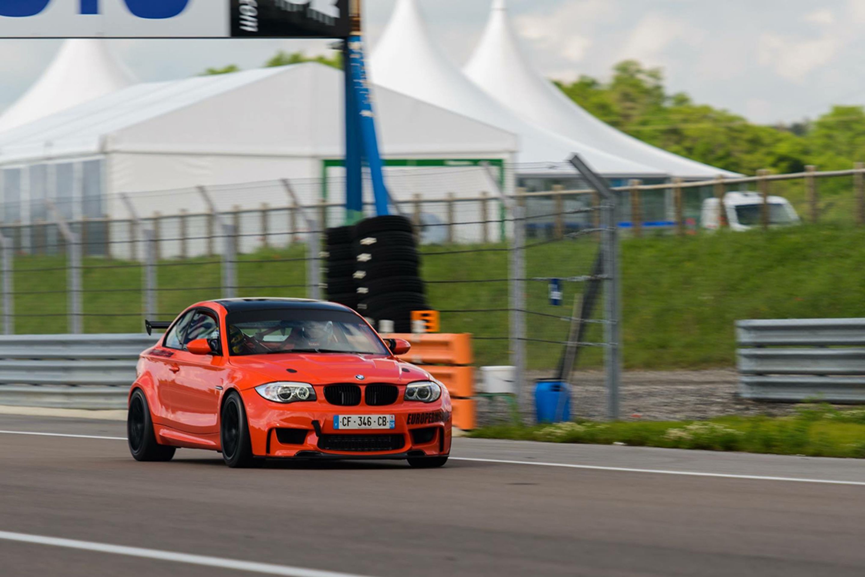 Orange BMW E82 1M with 18" EC-7 Apex wheels in Satin Black