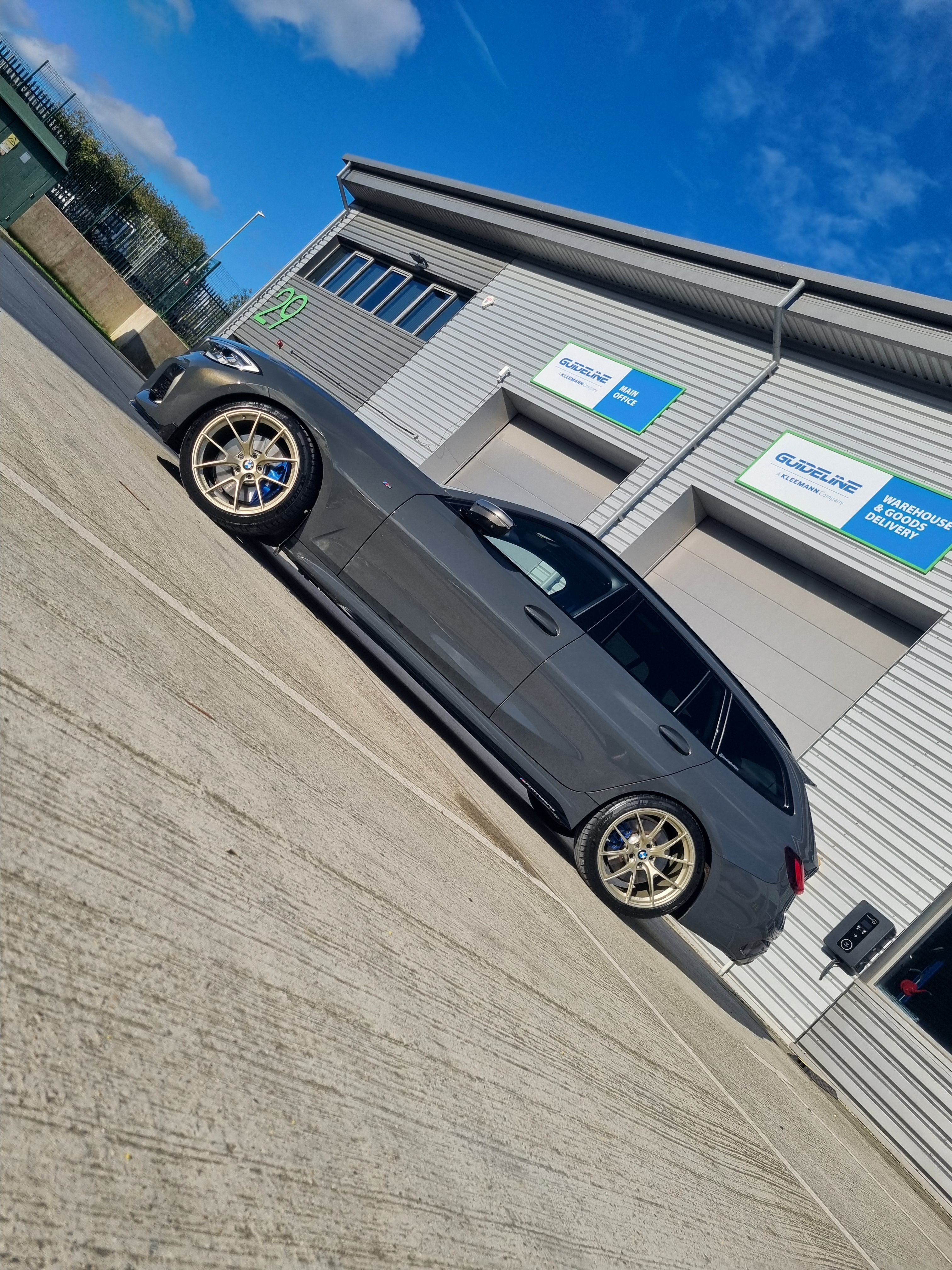 Black BMW G21 Wagon 3 Series with 19" VS-5RS Apex wheels in Motorsport Gold