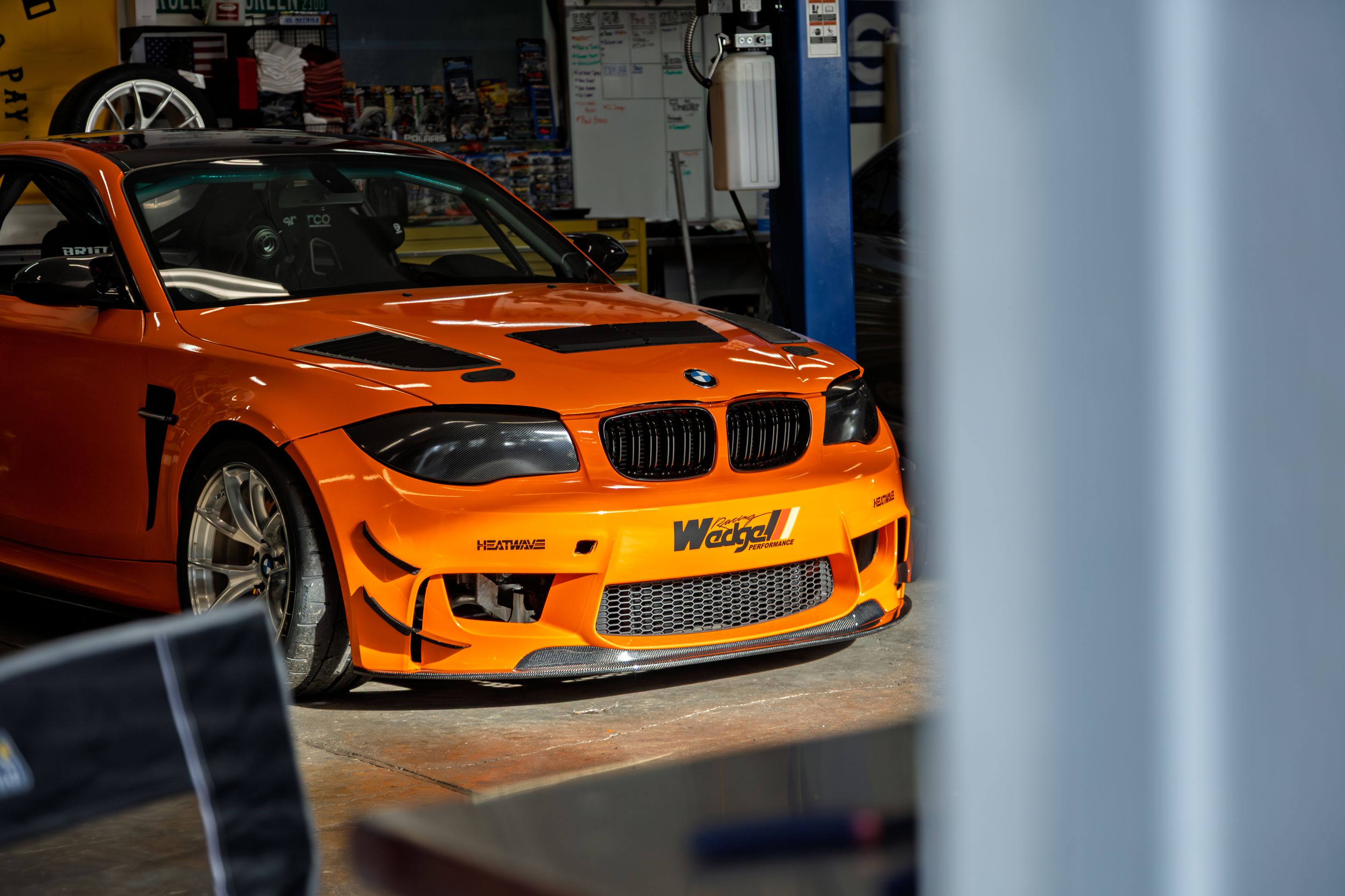 Orange BMW E82 1M with 18" VS-5RS Apex wheels in Brushed Clear