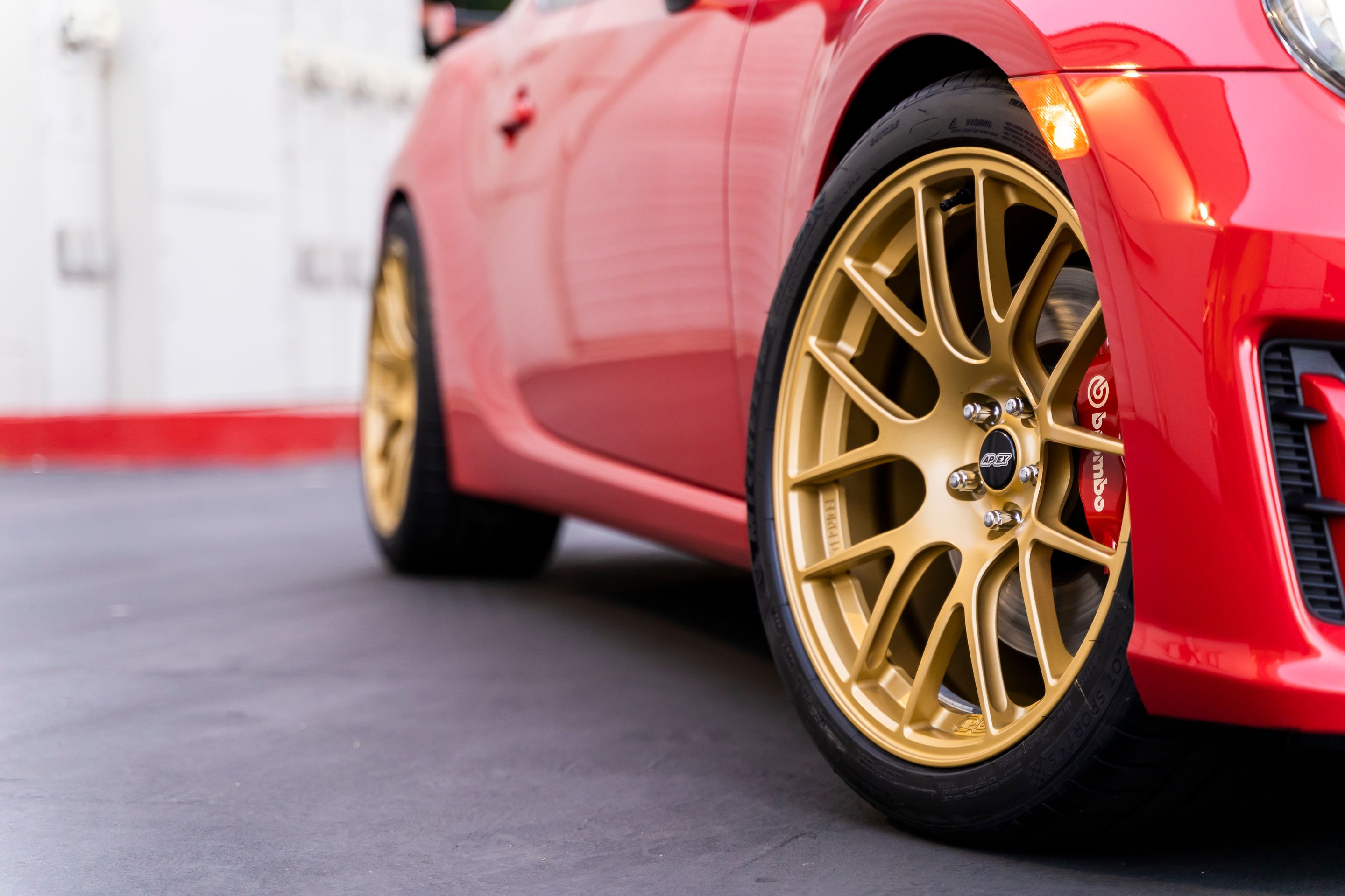 Red Subaru ZC6 / Gen 1 BRZ with 18" EC-7R Apex wheels in Satin Gold