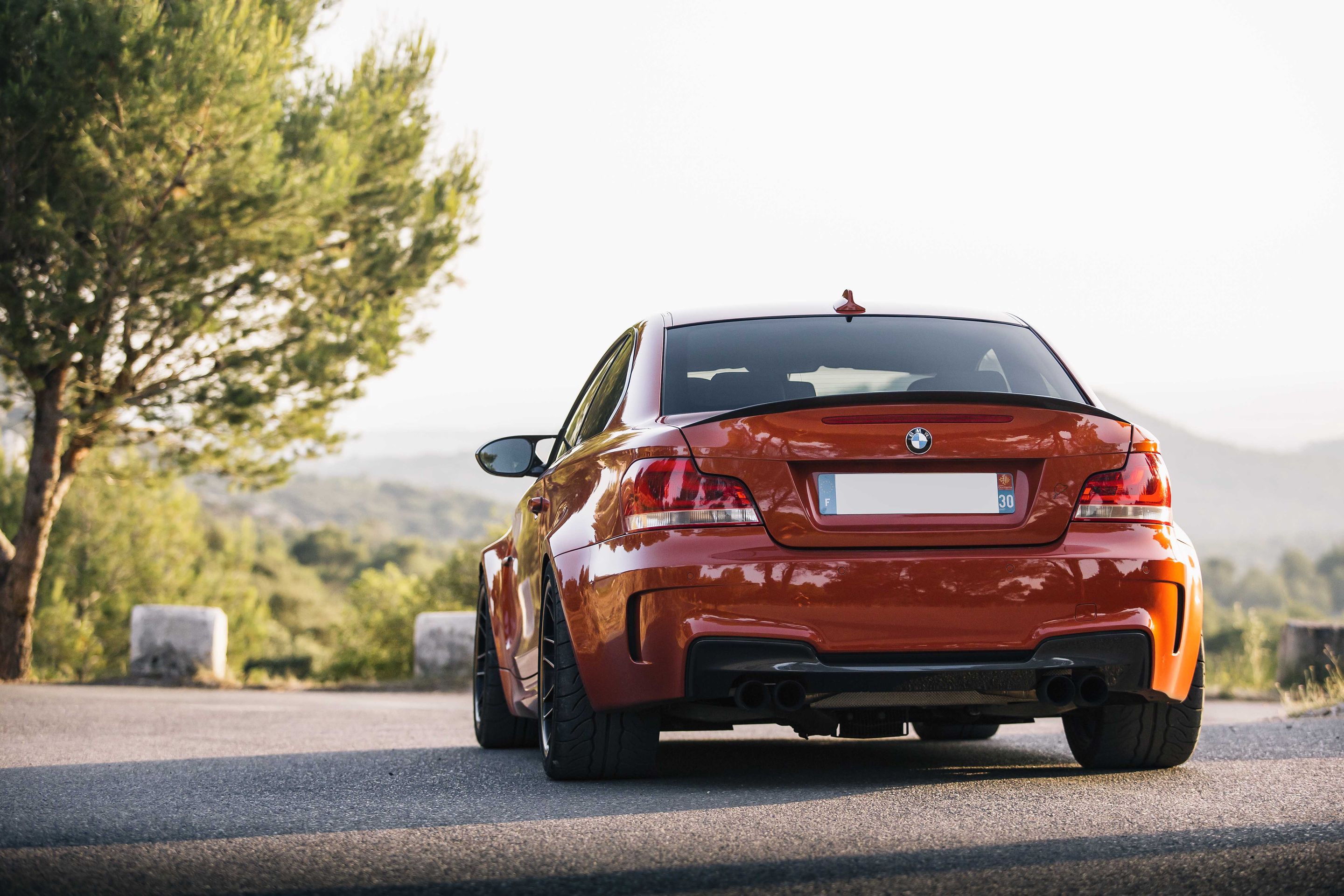 Orange BMW E82 1M with 18" ARC-8 Apex wheels in Satin Black