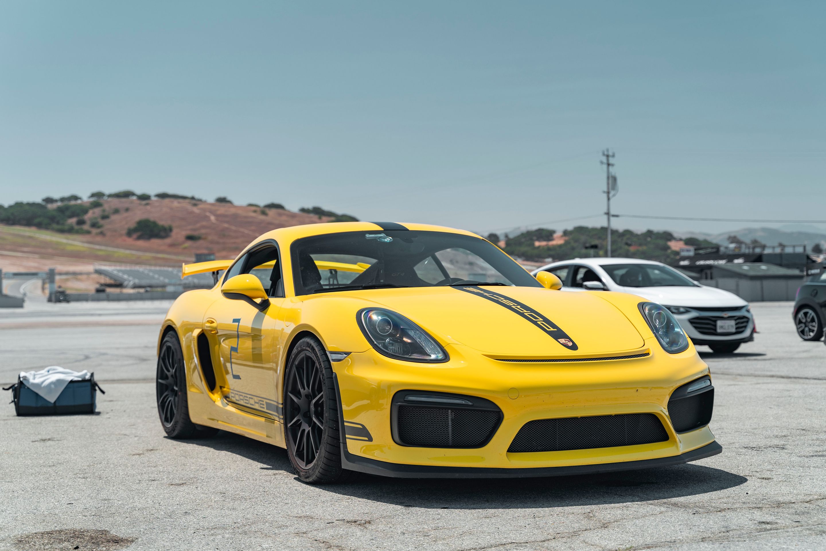 Yellow Porsche 981 Cayman GT4 with 19" SM-10 Apex wheels in Satin Black