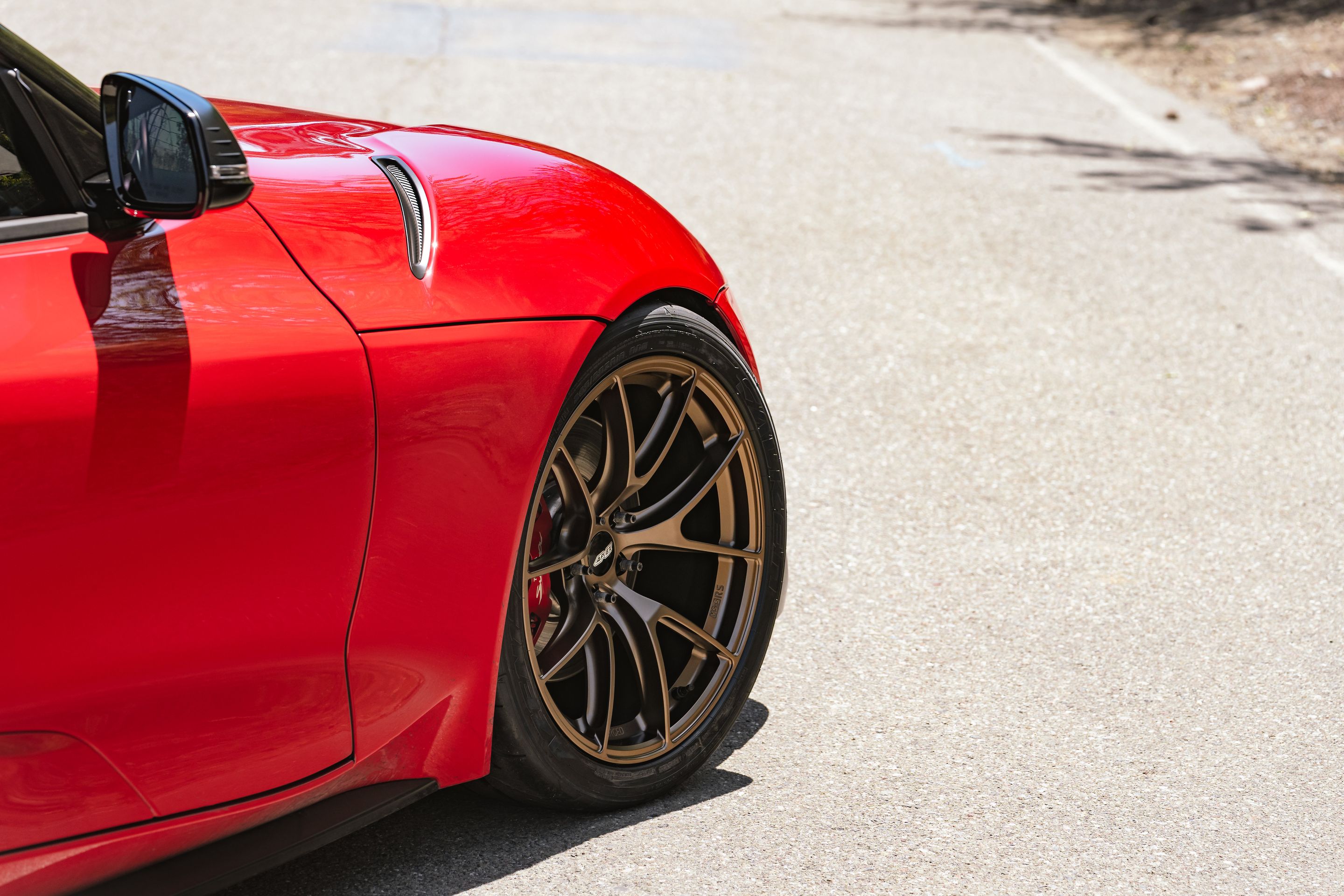 Red Toyota GR Supra with 19" VS-5RS Apex wheels in Satin Bronze