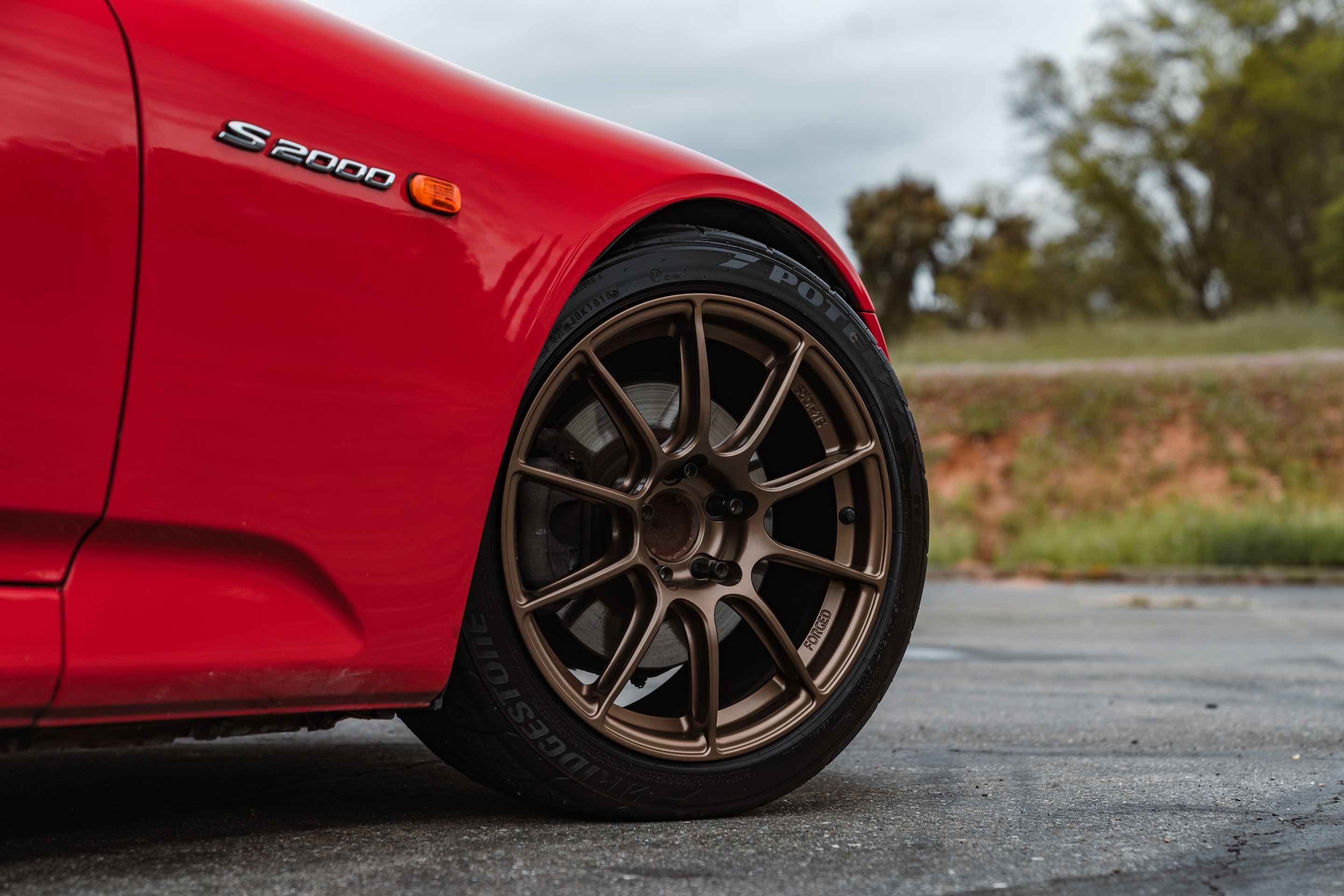 Red Honda S2000 with 17" SM-10RS Apex wheels in Satin Bronze