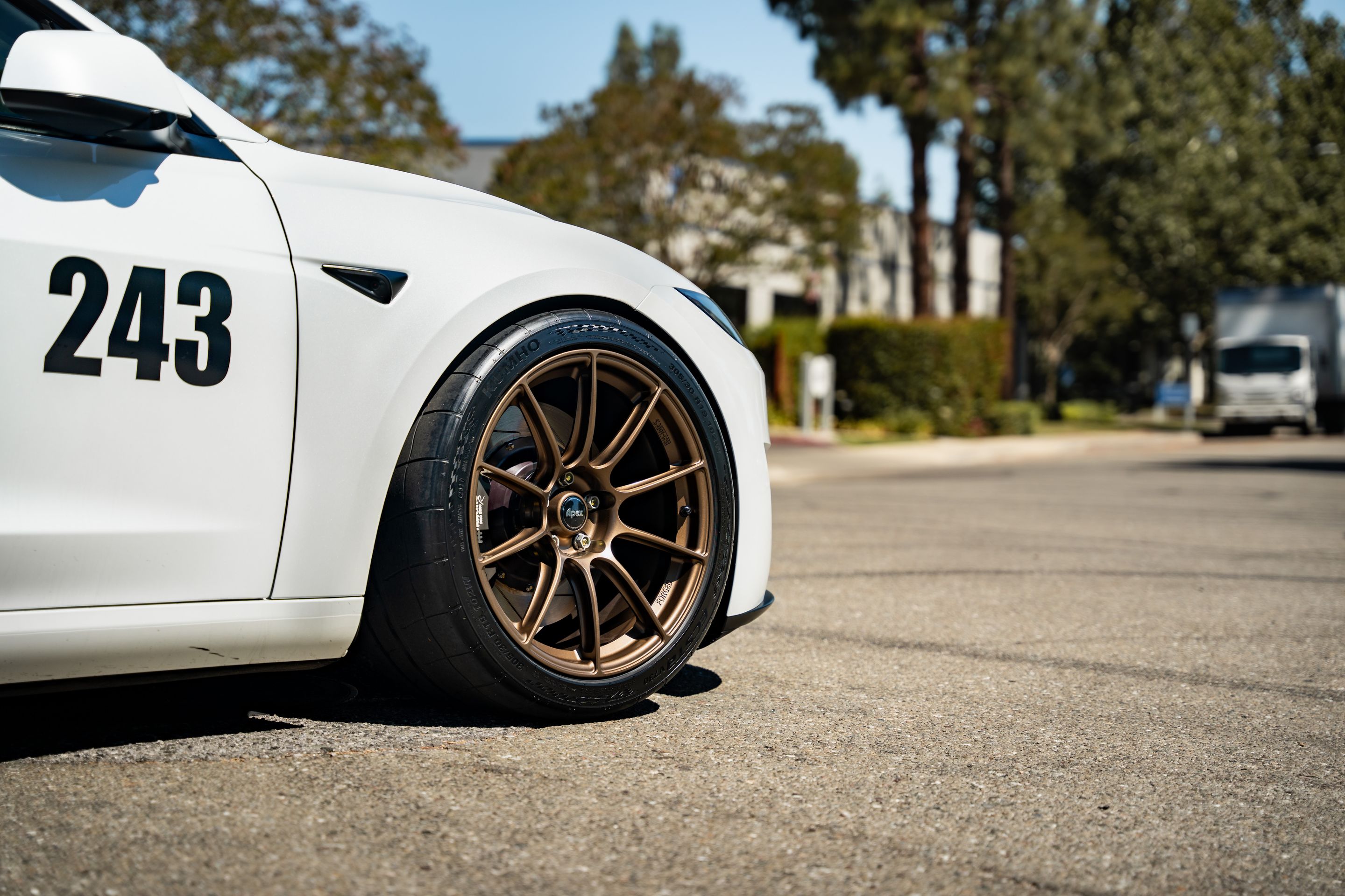 White Tesla Model 3 with 19" SM-10RS Apex wheels in Satin Bronze