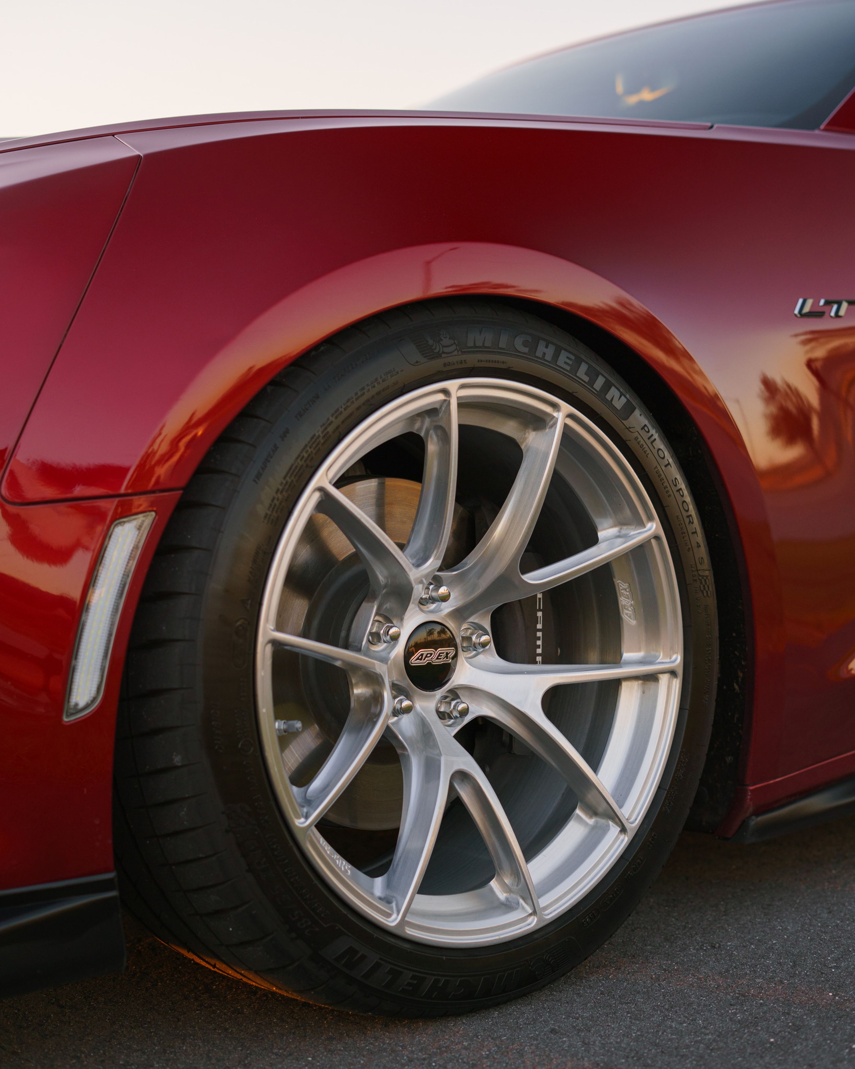 Red Chevrolet 6th Gen Camaro LT1 with 19" VS-5RS Apex wheels in Brushed Clear