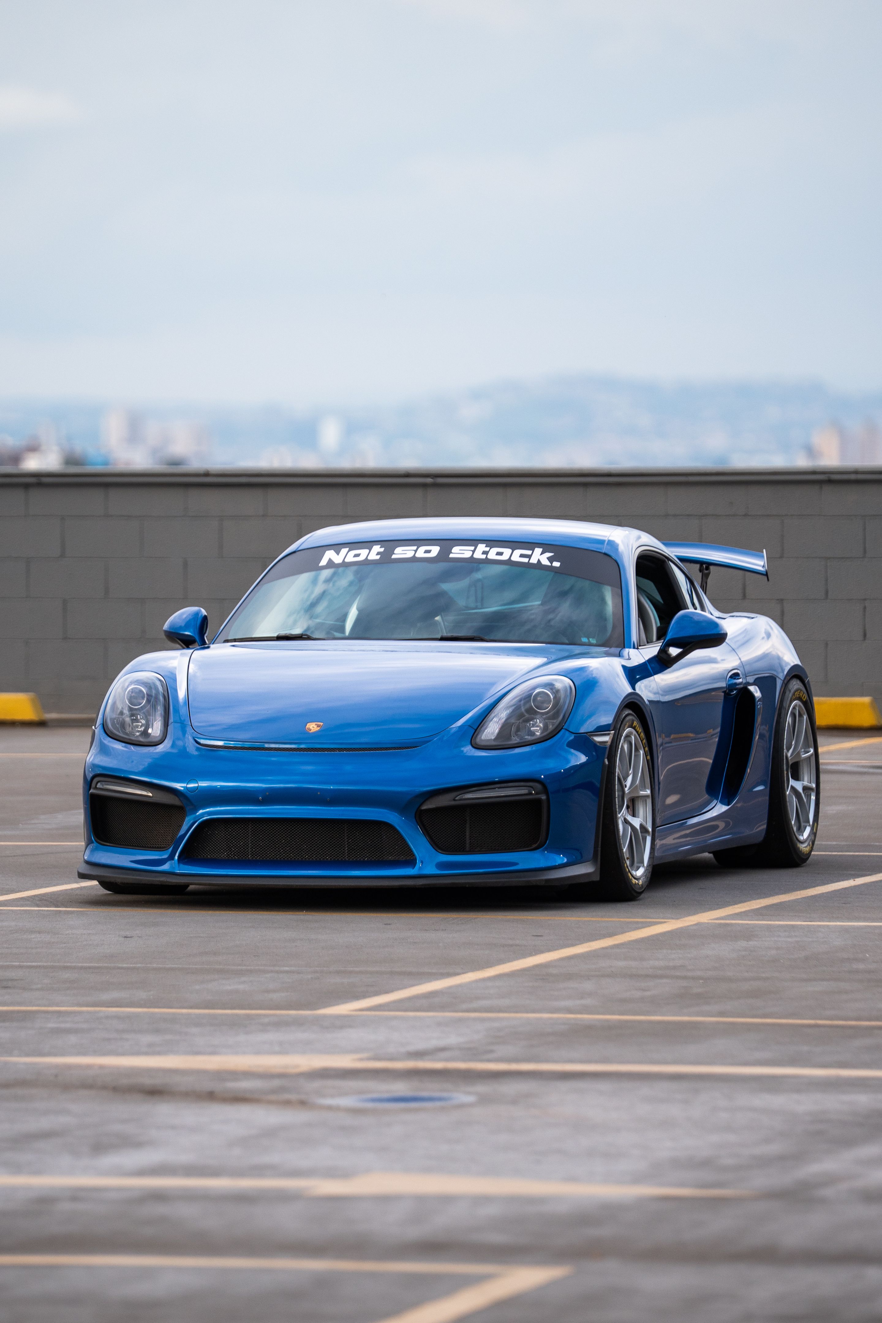 Blue Porsche 981 Cayman GT4 with 18" VS-5RE Apex wheels in Race Silver