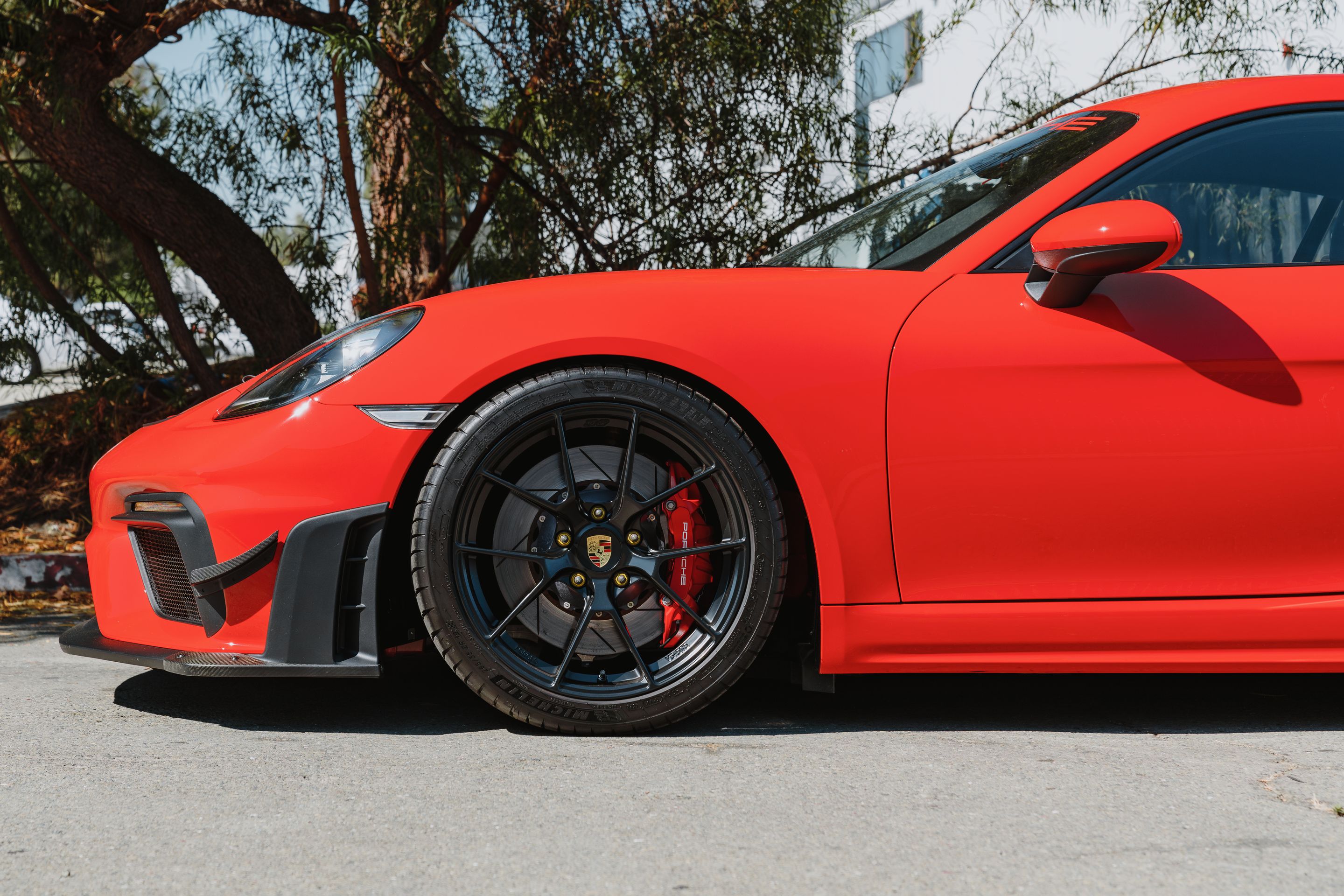 Red Porsche 718 Cayman GT4 with 19" VS-5RS Apex wheels in Satin Black