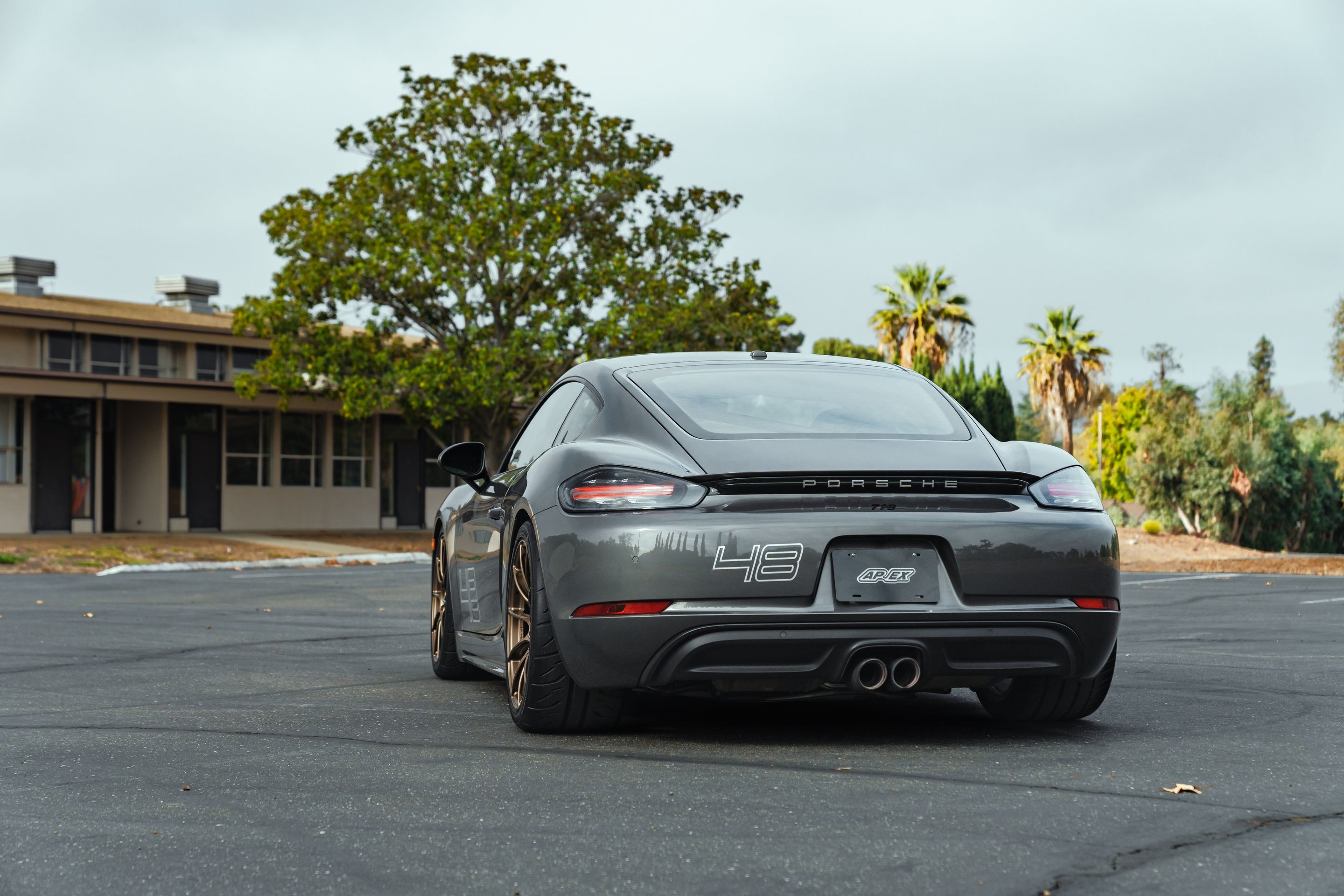Grey Porsche 718 Cayman S with 19" SM-10RS Apex wheels in Satin Bronze