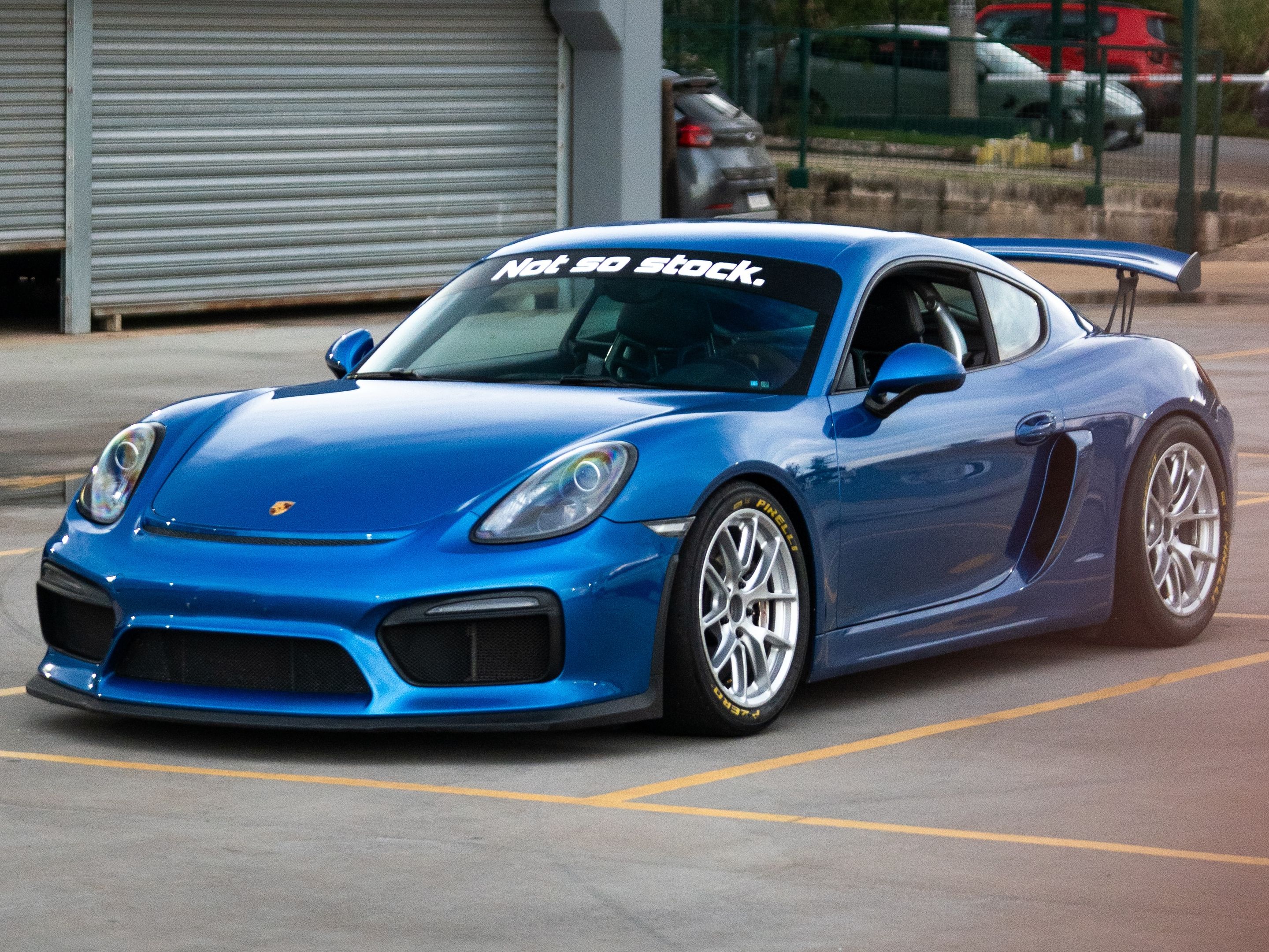 Blue Porsche 981 Cayman GT4 with 18" VS-5RE Apex wheels in Race Silver