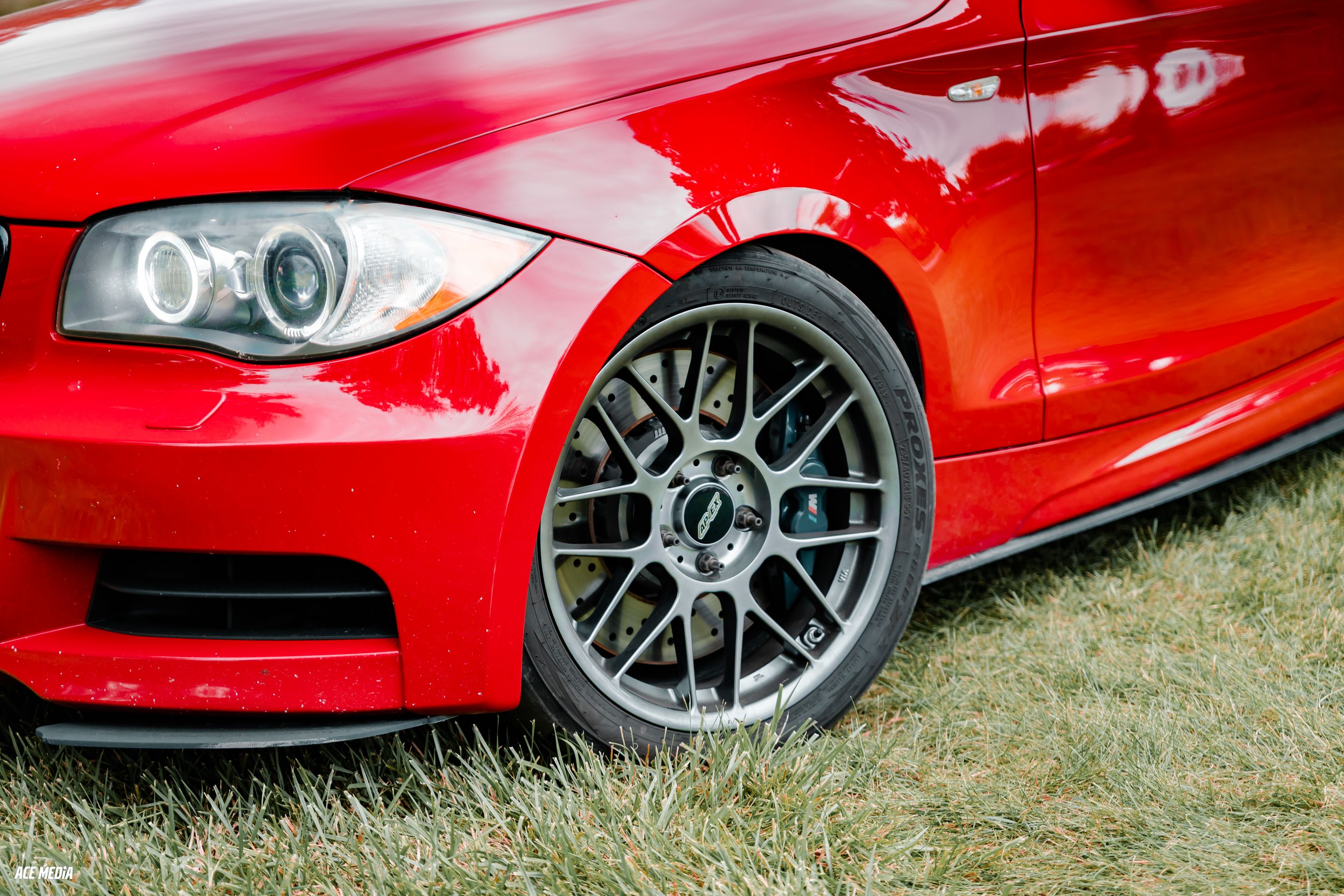 Red BMW E82 Coupe 1 Series with 18" ARC-8 Apex wheels in Hyper Black
