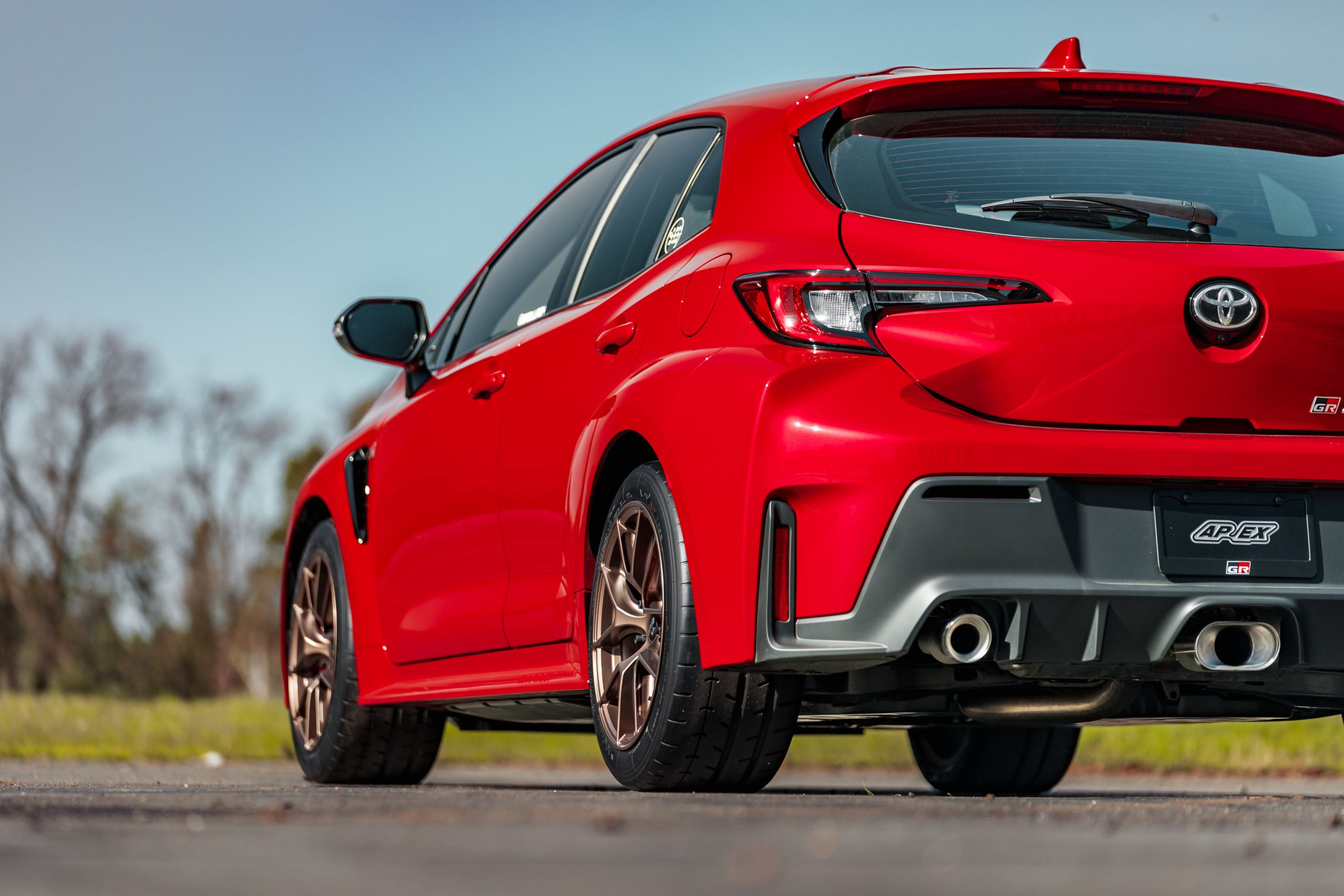 Red Toyota GR Corolla with 17" VS-5RS Apex wheels in Satin Bronze