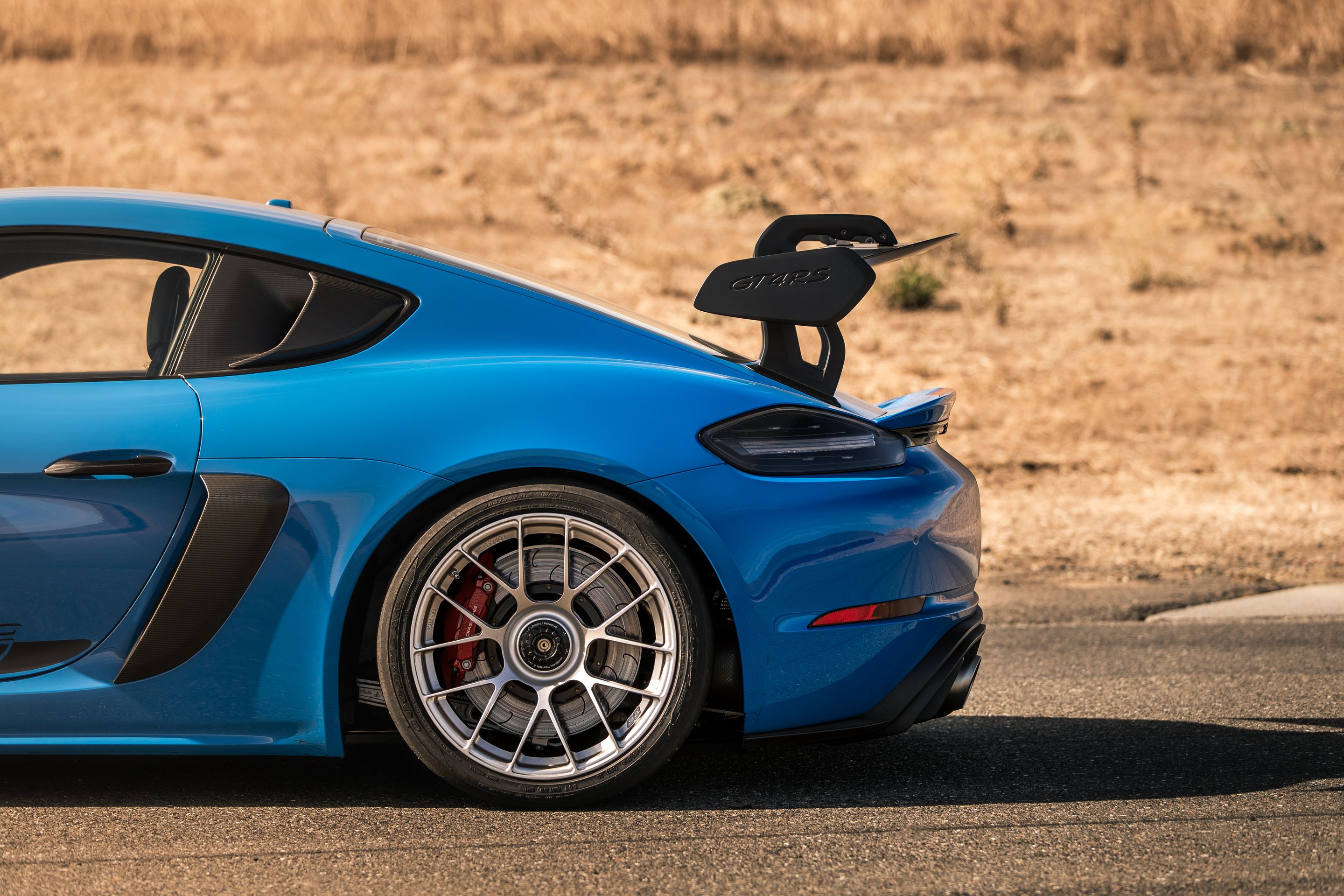 Blue Porsche 718 Cayman GT4 RS with 19" EC-7RS Apex wheels in Race Silver