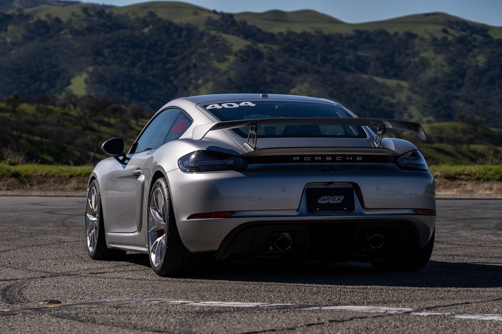 Grey Porsche 718 Cayman GT4 with 19" VS-5RS Apex wheels in Brushed Clear