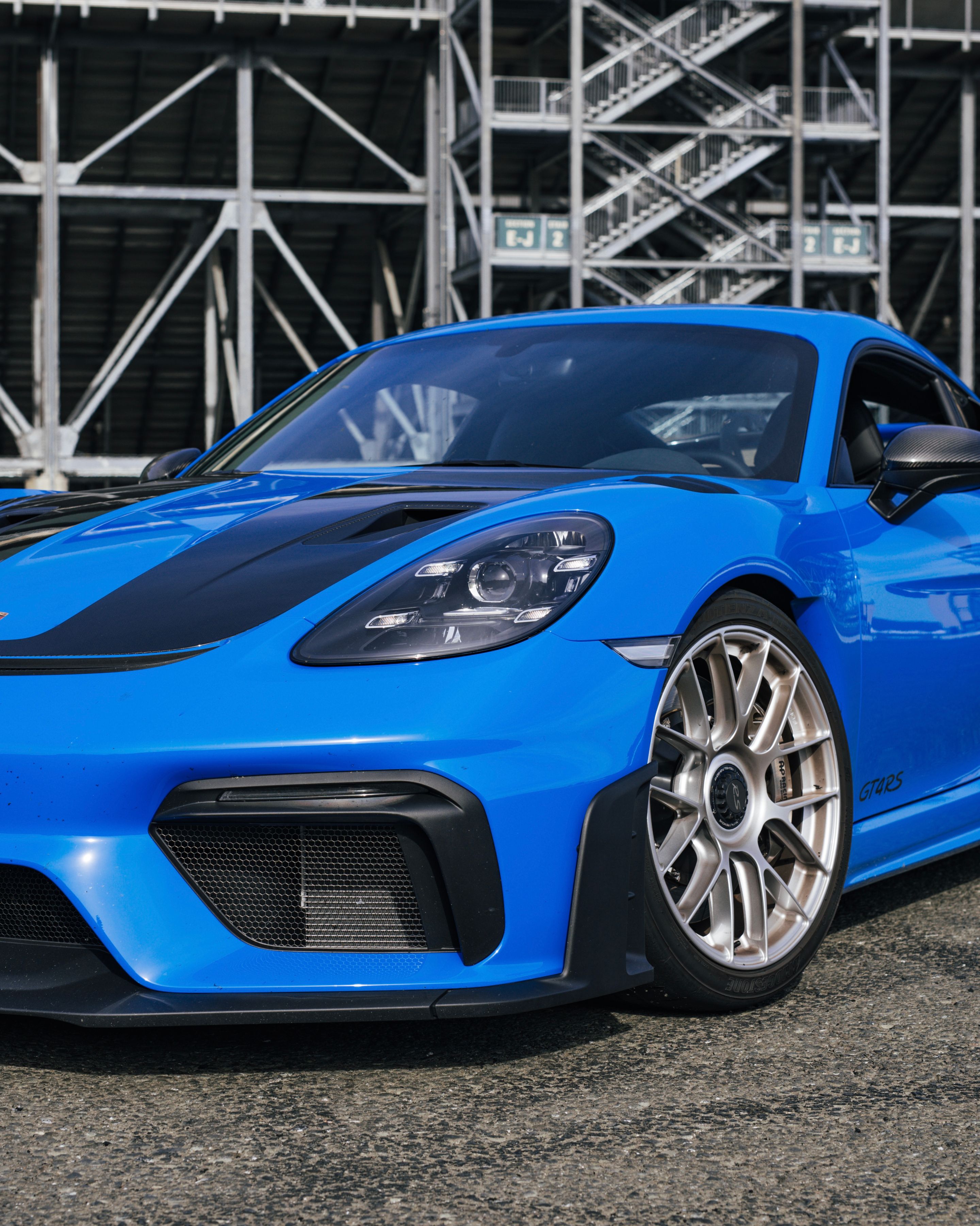 Blue Porsche 718 Cayman GT4 RS with 19" EC-7RS Apex wheels in Race Silver
