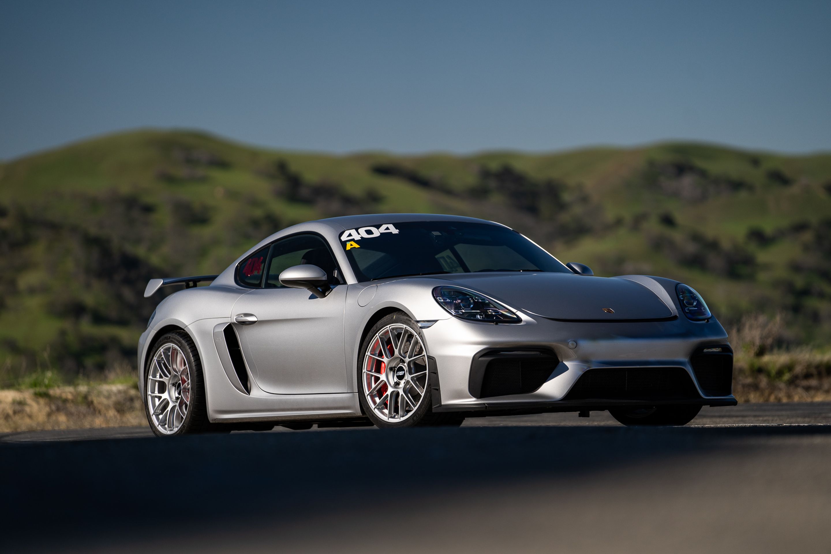 Grey Porsche 718 Cayman GT4 with 19" EC-7RS Apex wheels in Race Silver