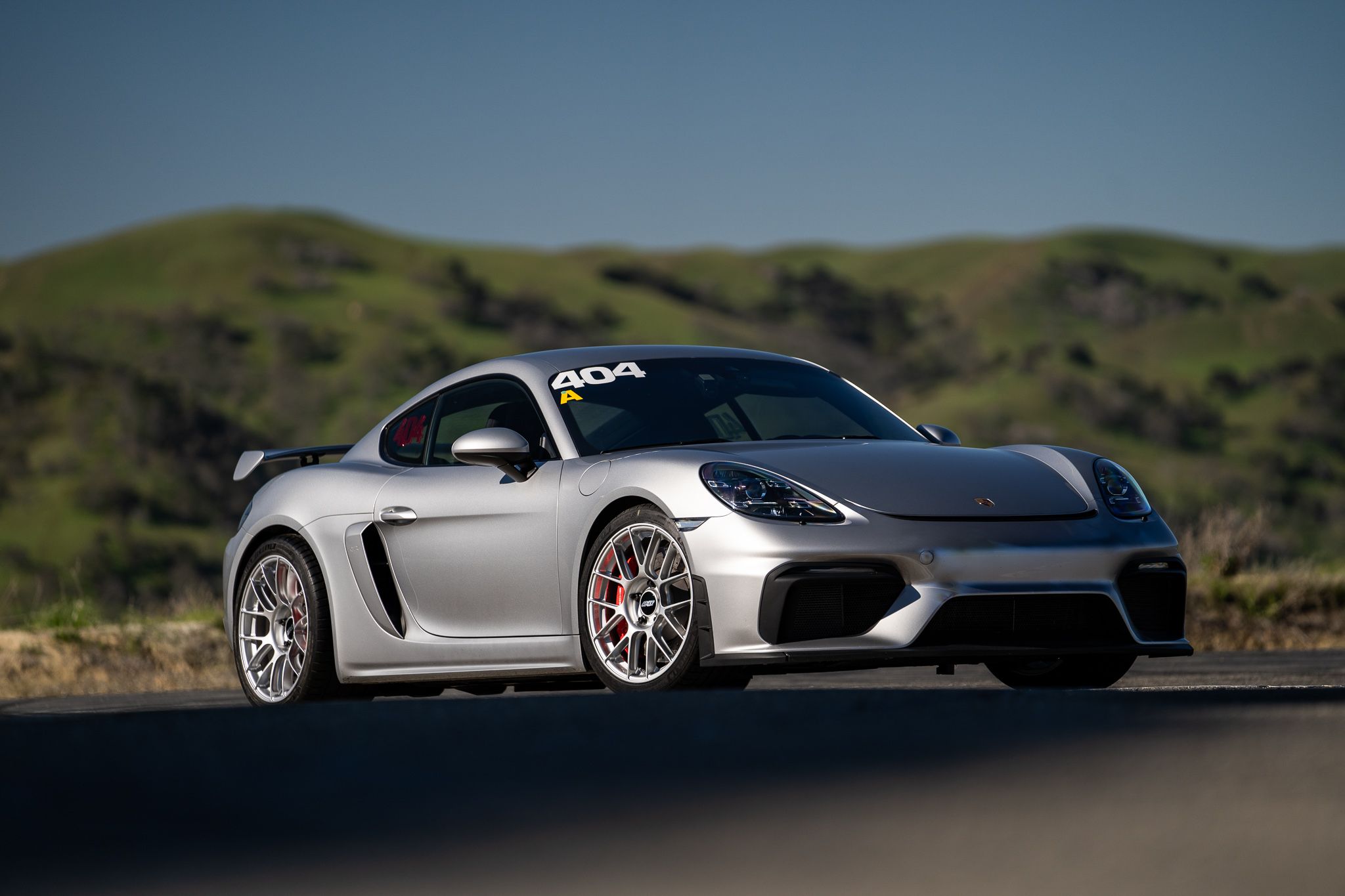 Grey Porsche 718 Cayman GT4 with 19" EC-7RS Apex wheels in Race Silver