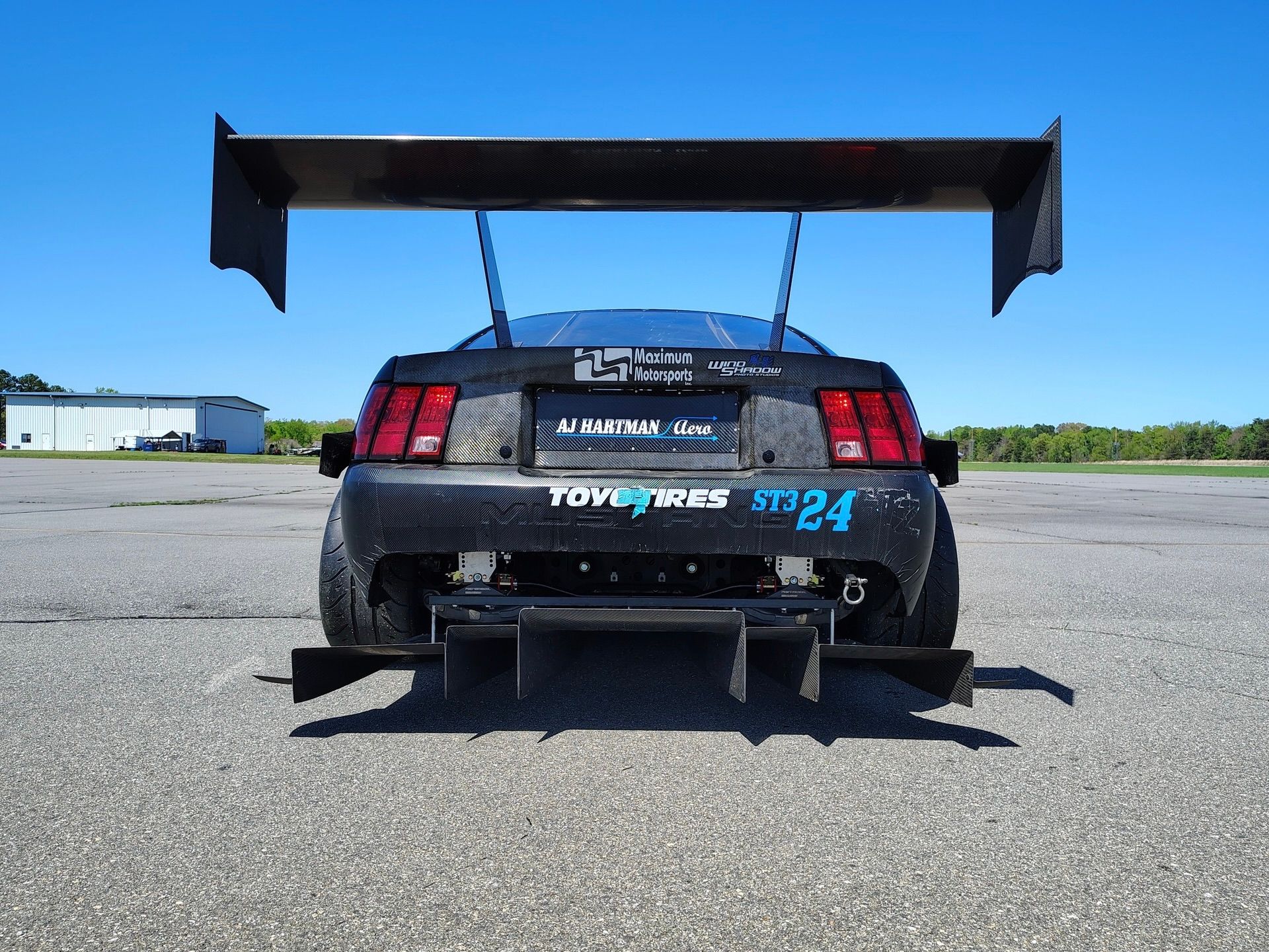 Black Ford SN95 Mustang V6 with 19" SM-10 Apex wheels in Satin Black