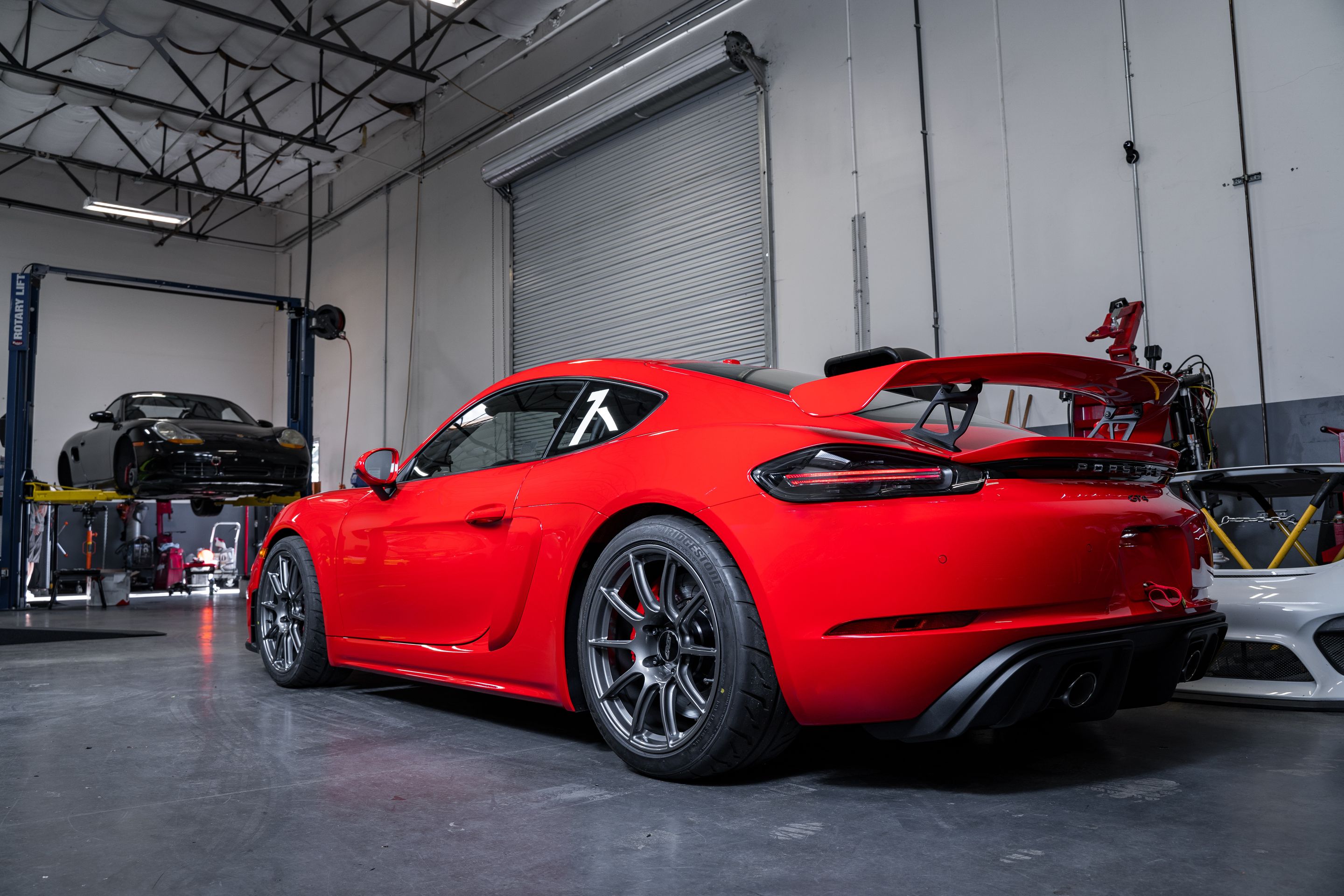 Red Porsche 718 Cayman GT4 with 19" SM-10 Apex wheels in Anthracite