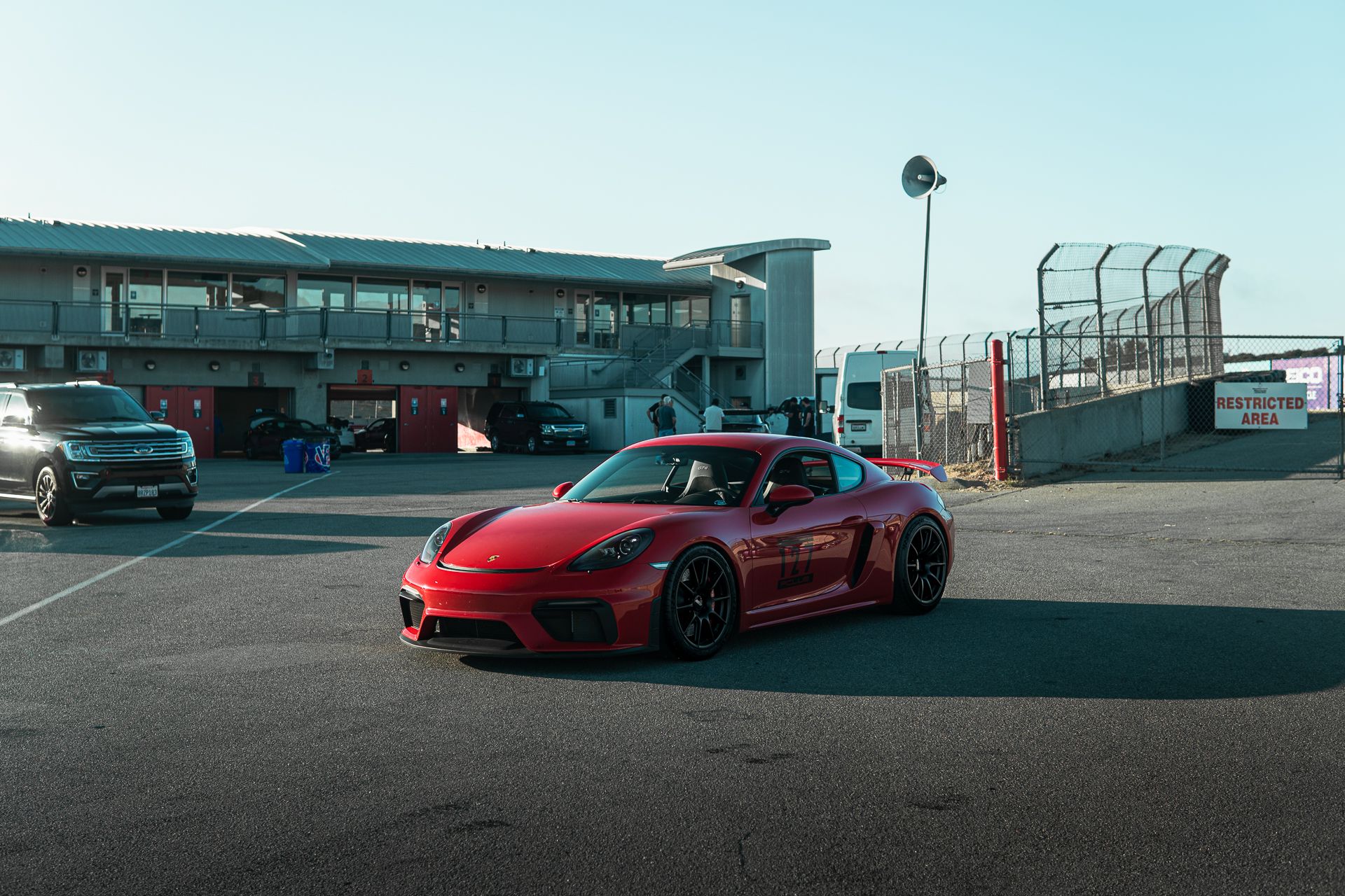 Red Porsche 718 Cayman GT4 with 19" SM-10 Apex wheels in Satin Black