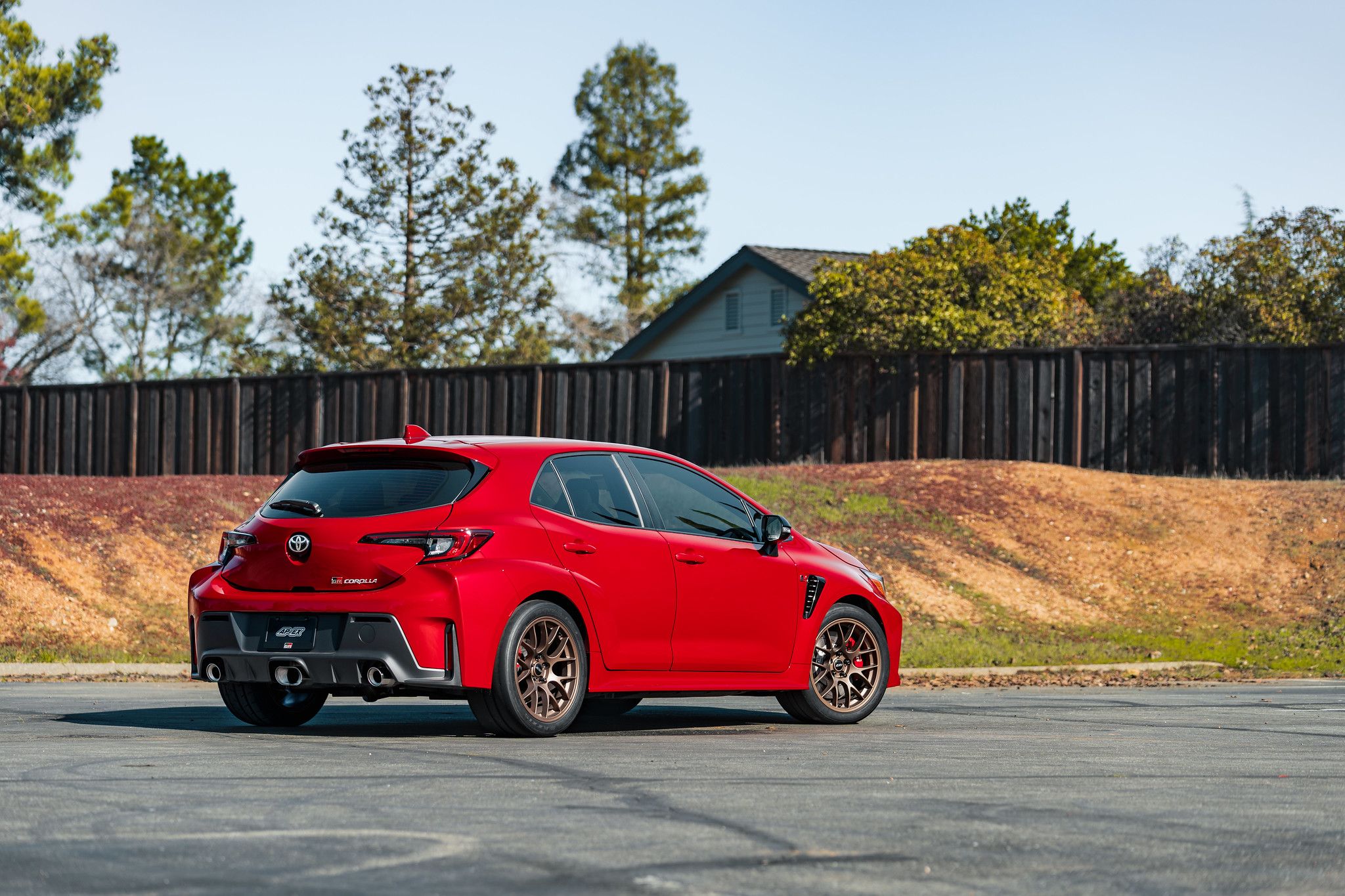 Red Toyota GR Corolla with 18" EC-7 Apex wheels in Satin Bronze