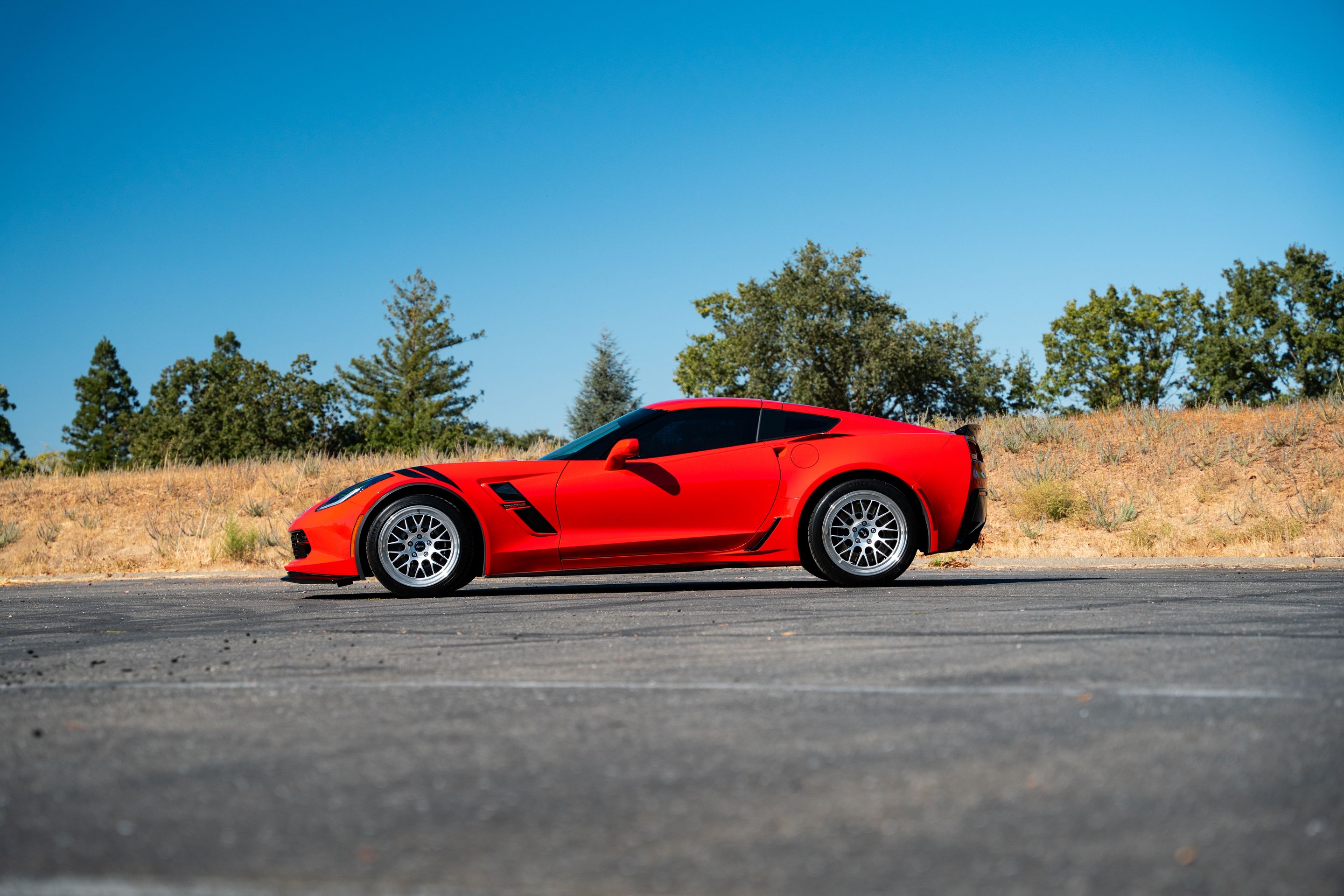 Red Chevrolet C7 Corvette Grand Sport with 18"/19" ML-10RT Apex wheels in Machined Lip Race Silver