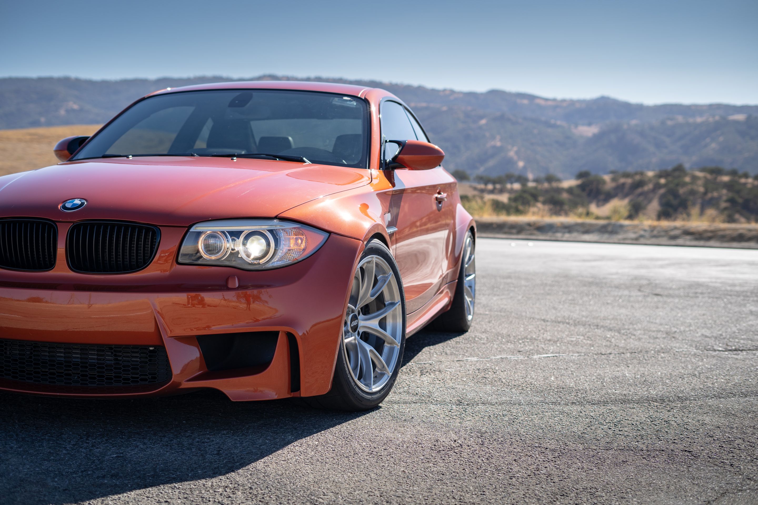 Orange BMW E82 1M with 18" VS-5RS Apex wheels in Brushed Clear