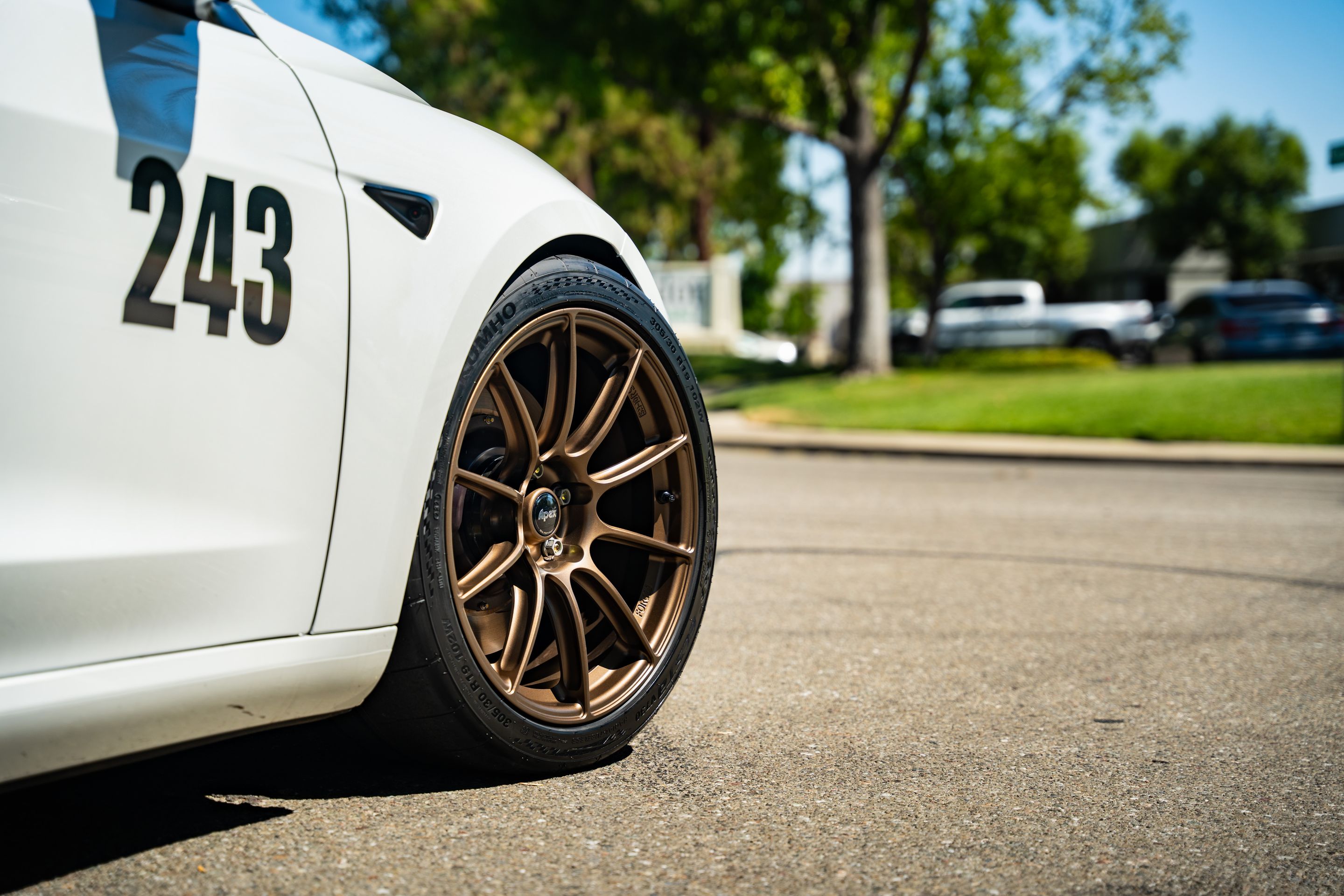 White Tesla Model 3 with 19" SM-10RS Apex wheels in Satin Bronze