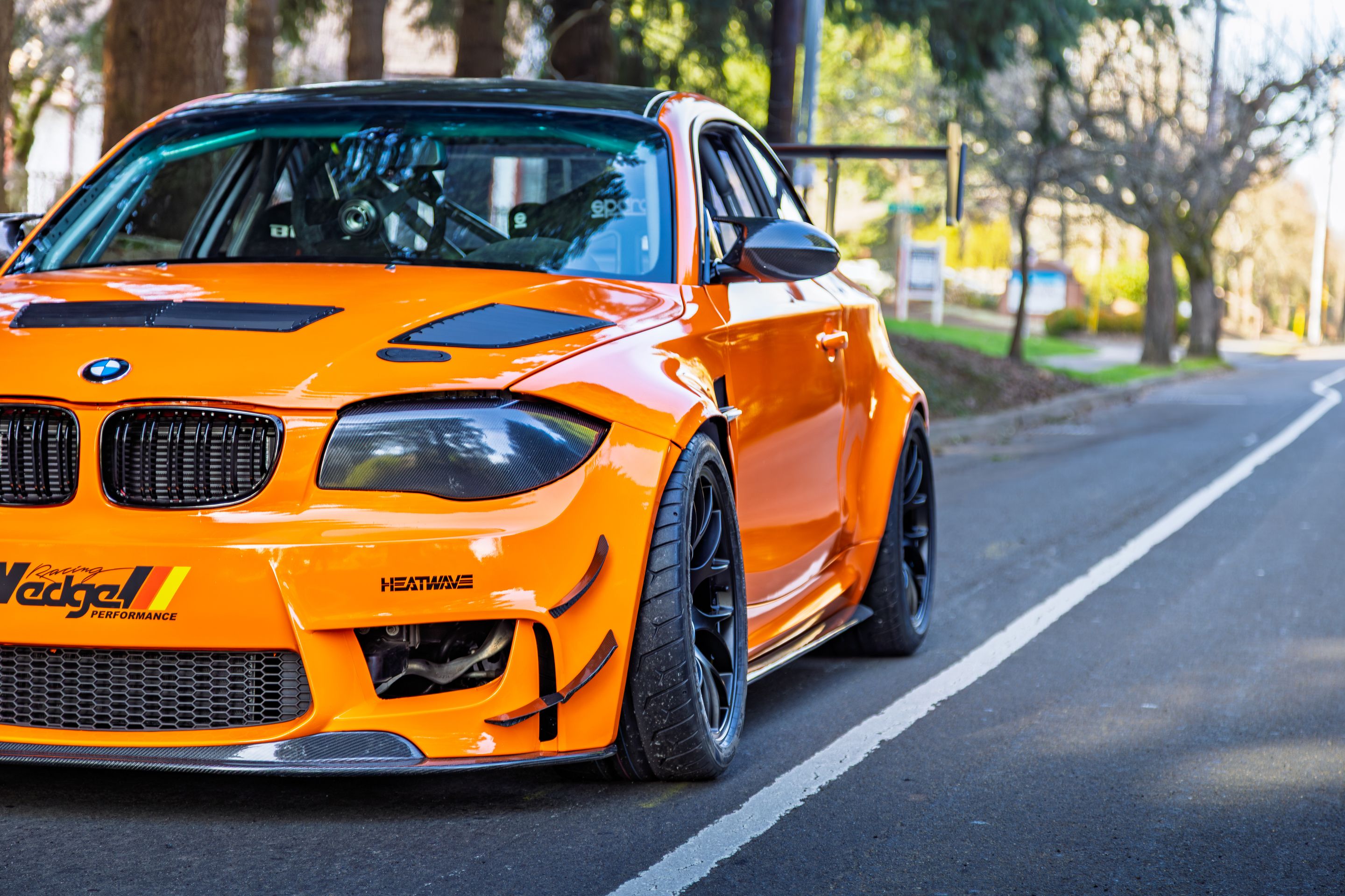 Orange BMW E82 1M with 18" EC-7 Apex wheels in Satin Black