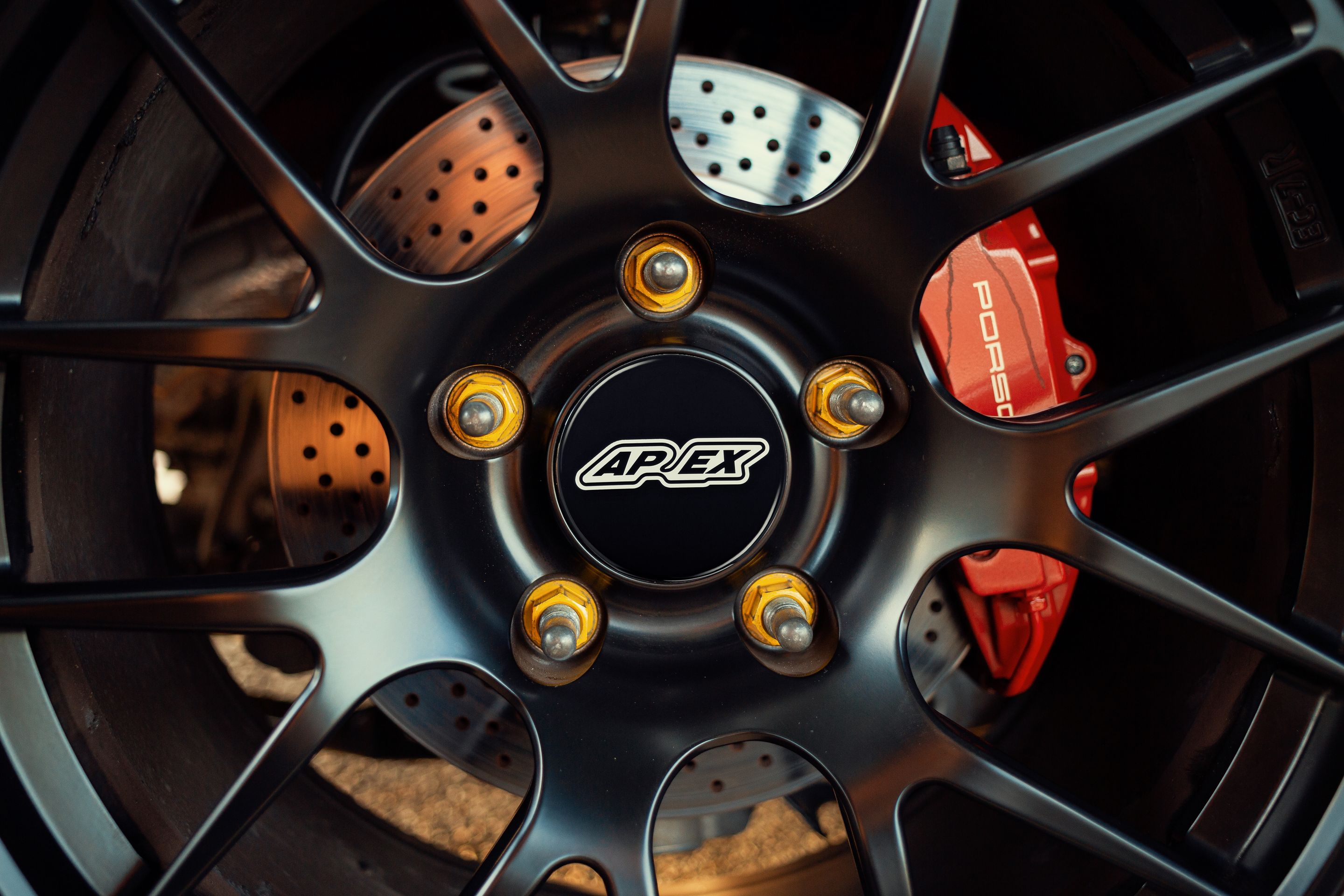 Red Porsche 981 Cayman S with 18" EC-7R Apex wheels in Satin Black