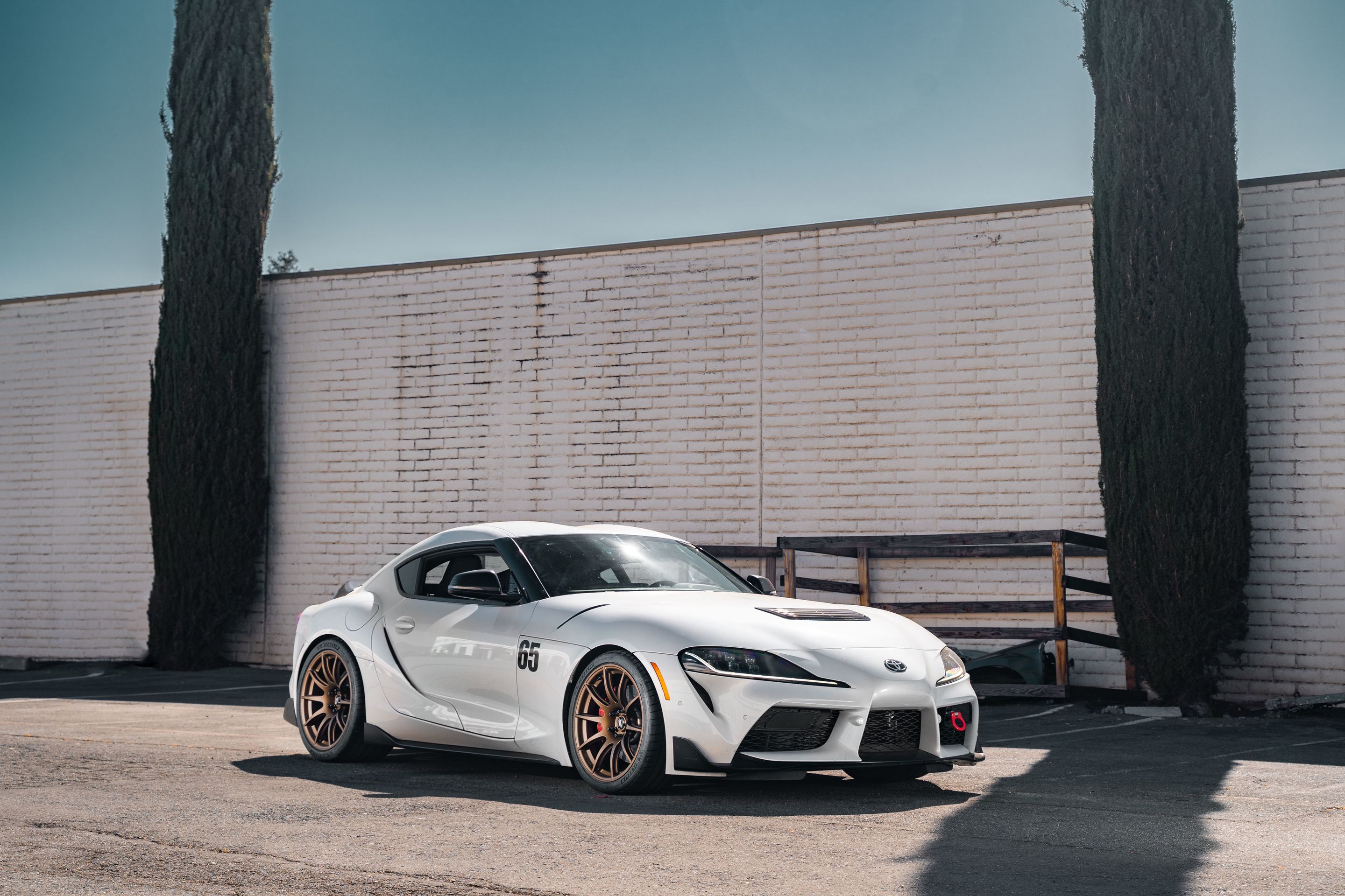 White Toyota GR Supra with 19" SM-10 Apex wheels in Satin Bronze