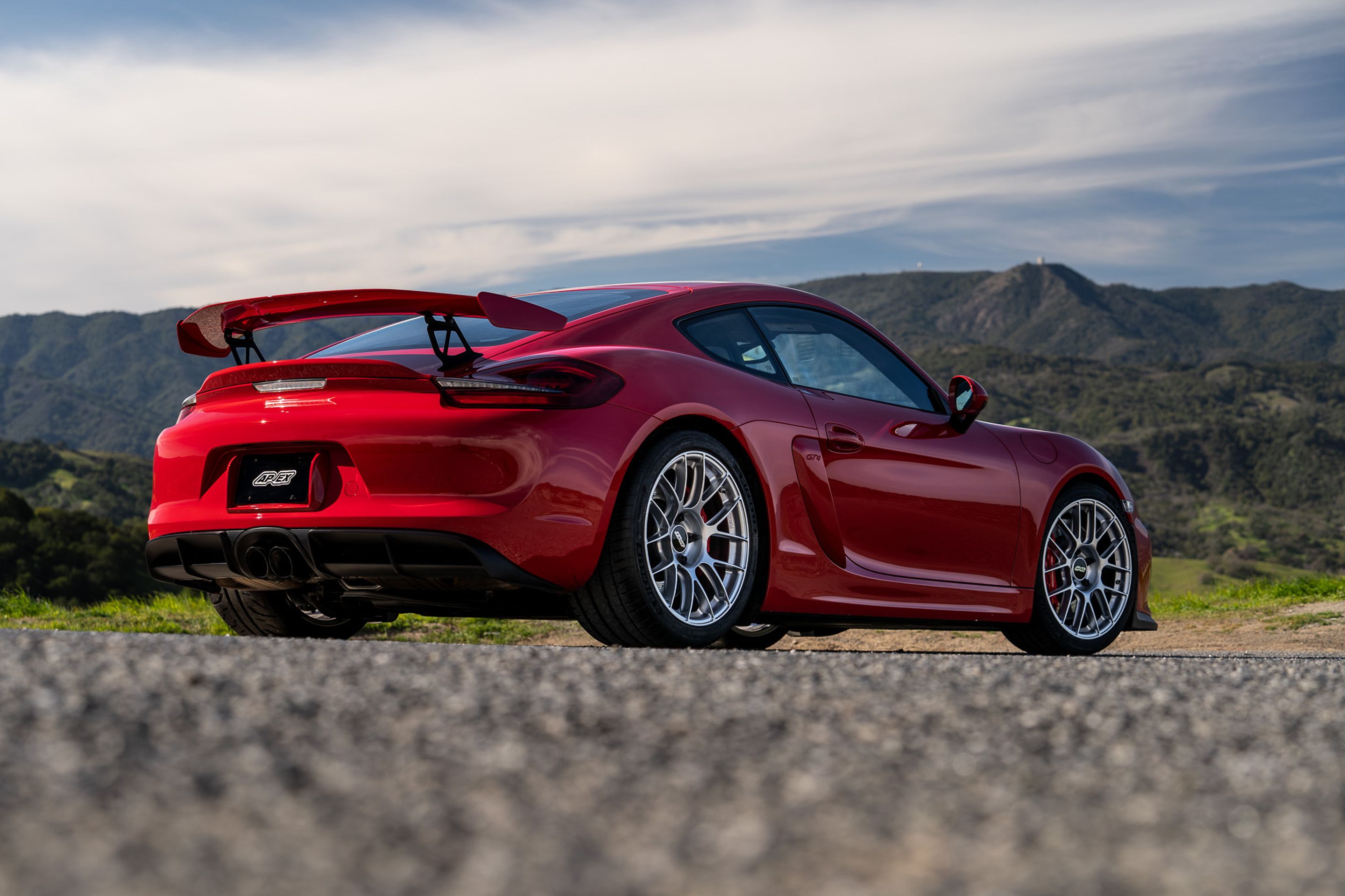 Red Porsche 981 Cayman GT4 with 19" EC-7RS Apex wheels in Race Silver