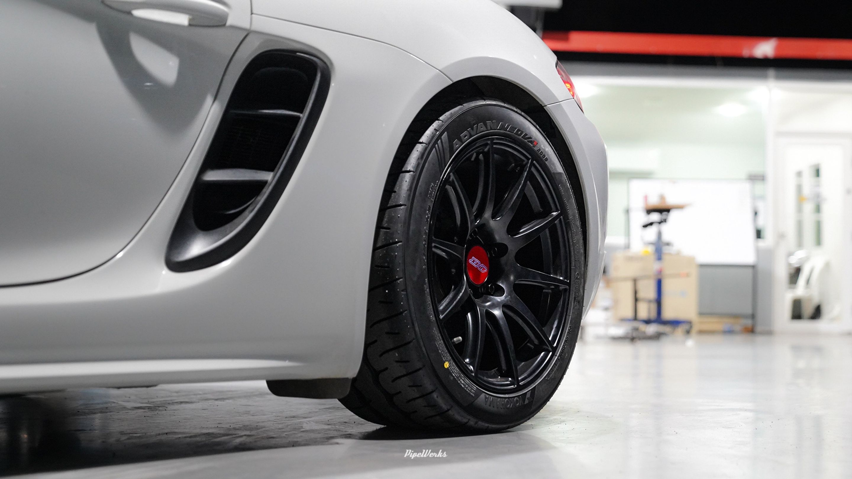 White Porsche 718 Cayman Base with 18" SM-10 Apex wheels in Satin Black