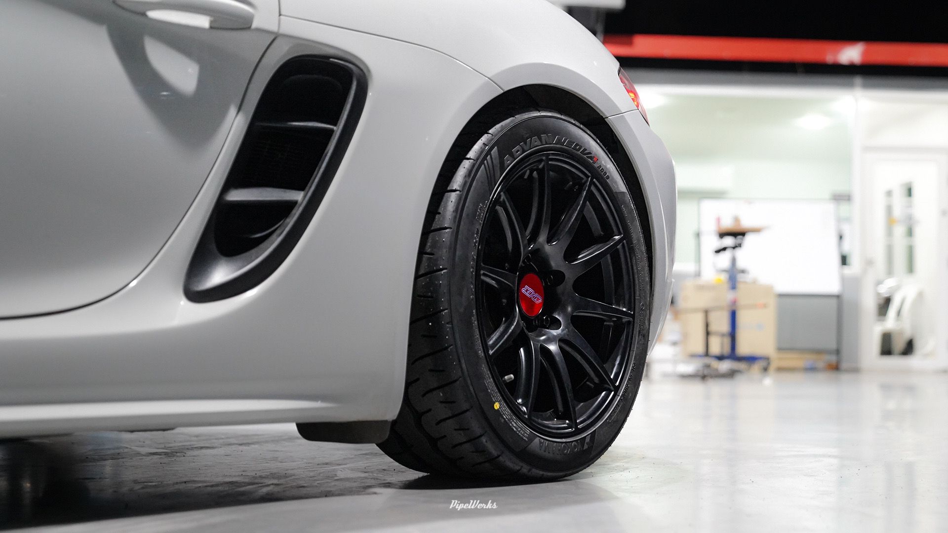 White Porsche 718 Cayman Base with 18" SM-10 Apex wheels in Satin Black