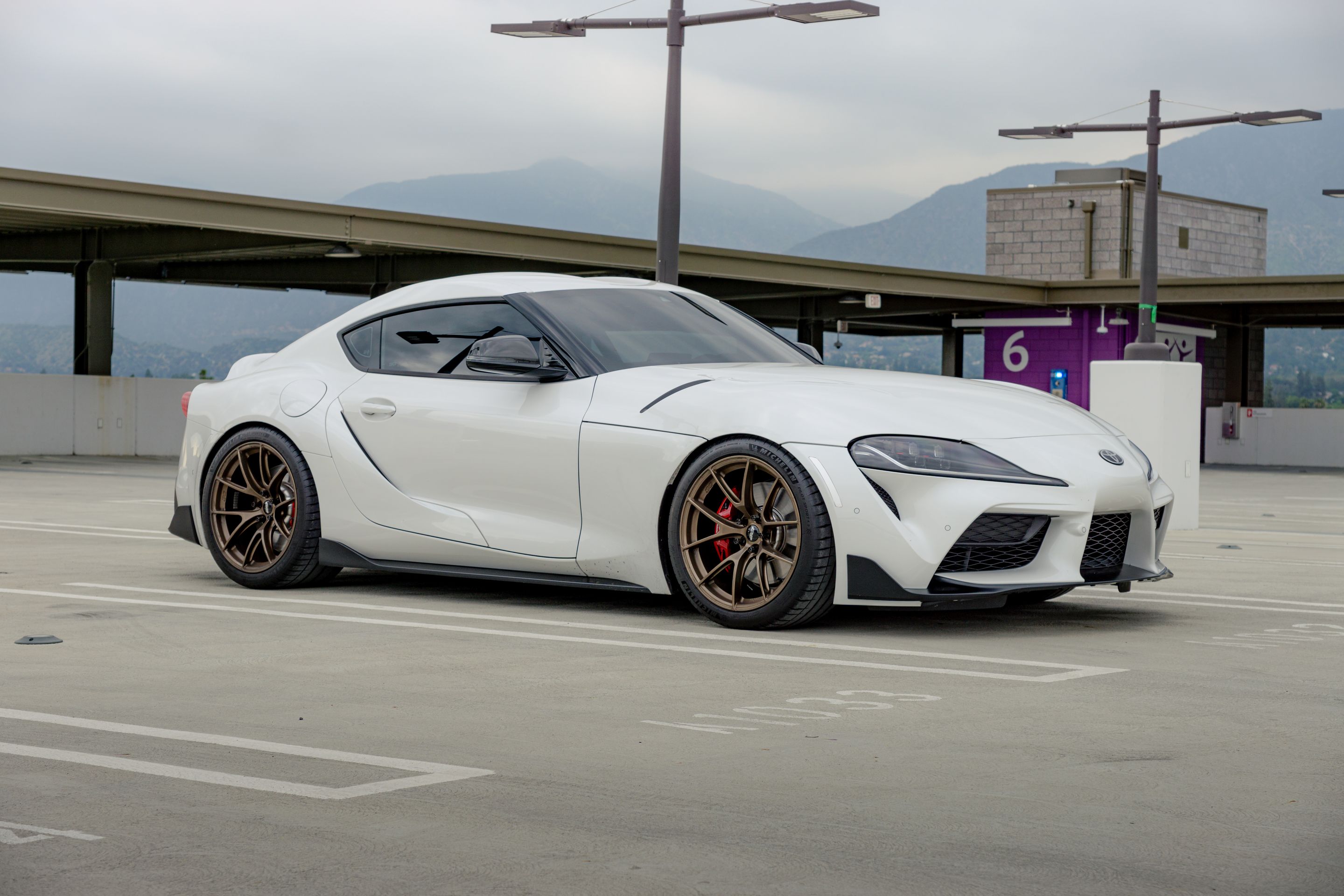 White Toyota GR Supra with 19" VS-5RS Apex wheels in Satin Bronze