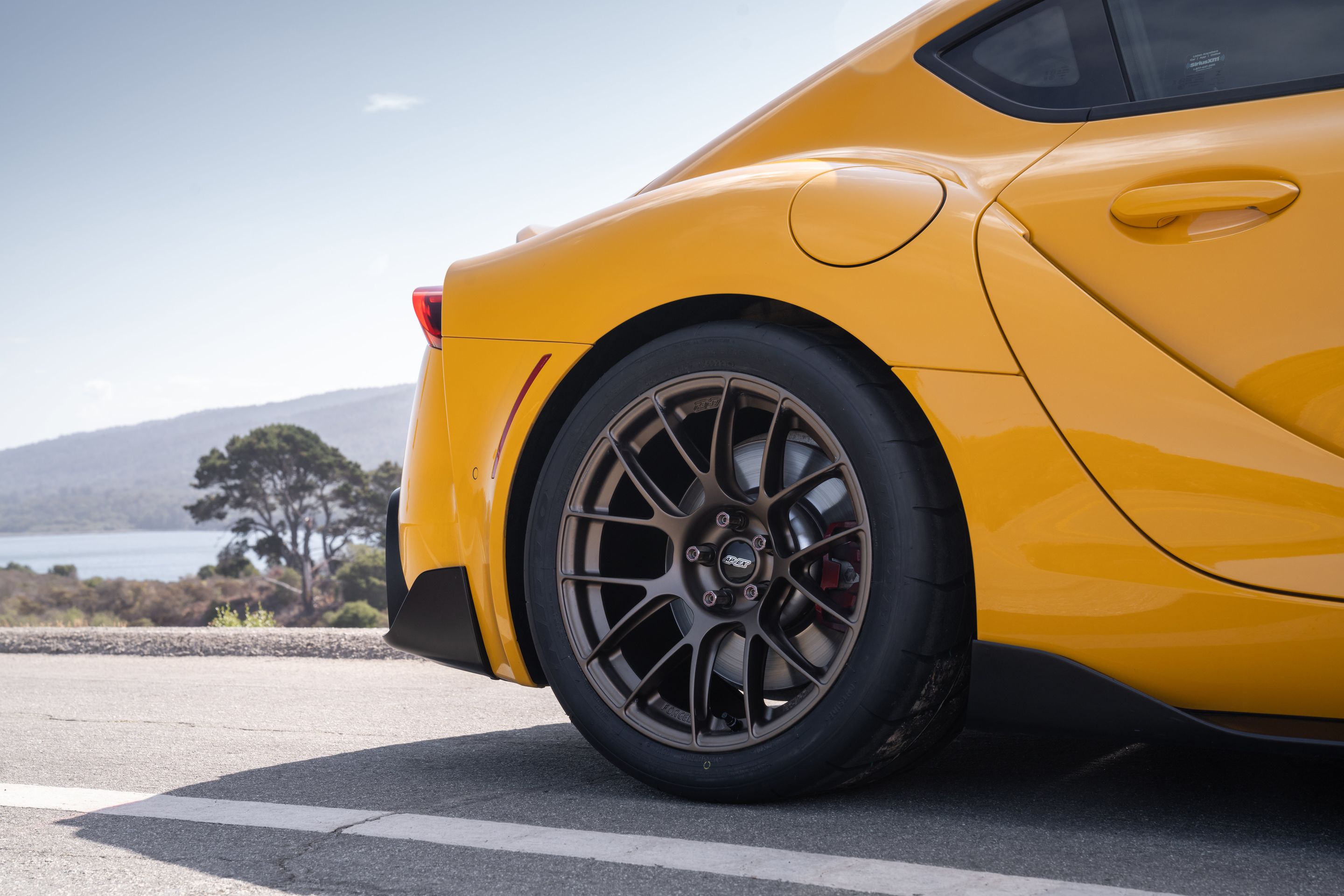 Yellow Toyota GR Supra with 18" EC-7RS Apex wheels in Satin Bronze
