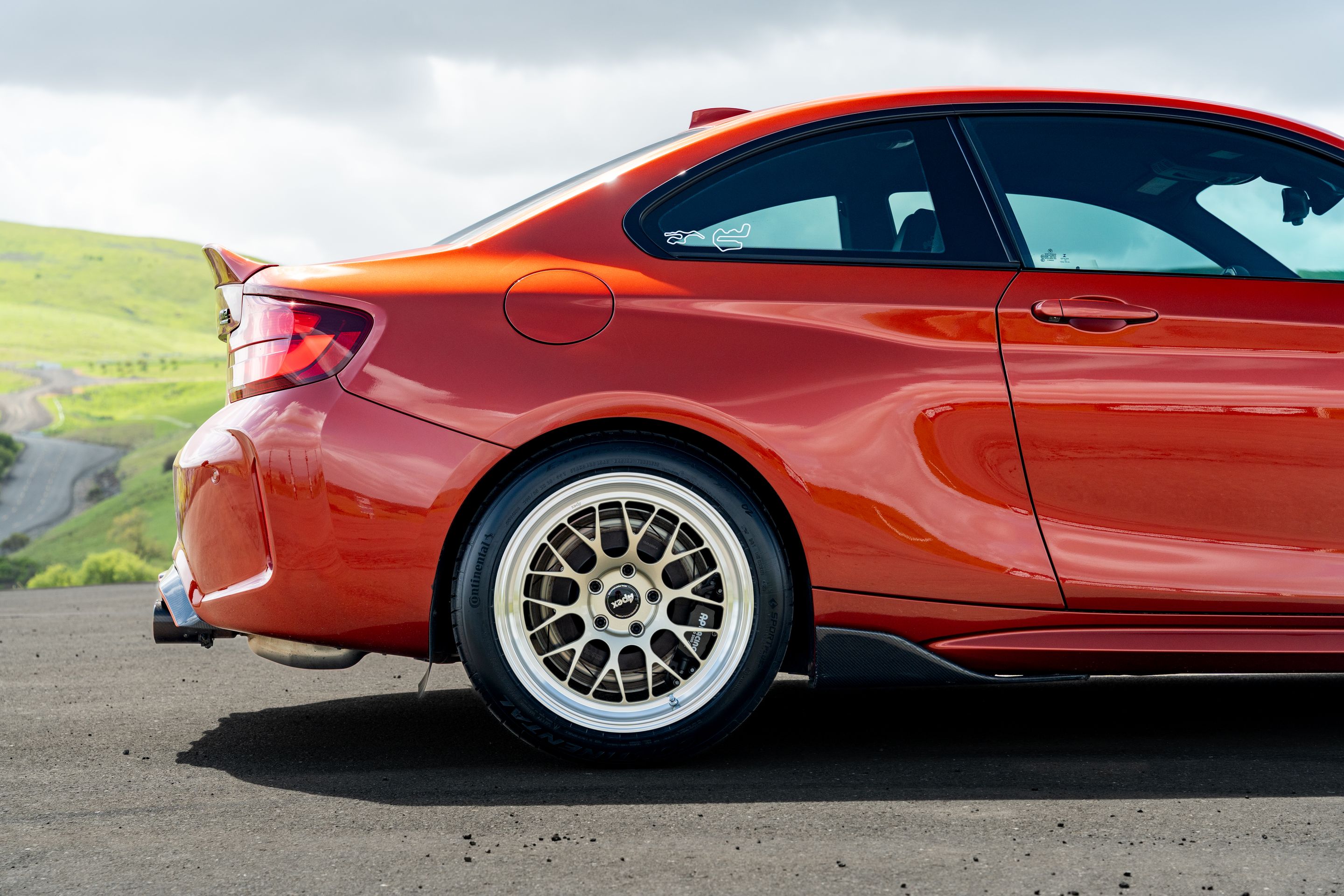 Orange BMW F87 M2 with 18" ML-10RT Apex wheels in Machined Lip Gloss Motorsport Gold