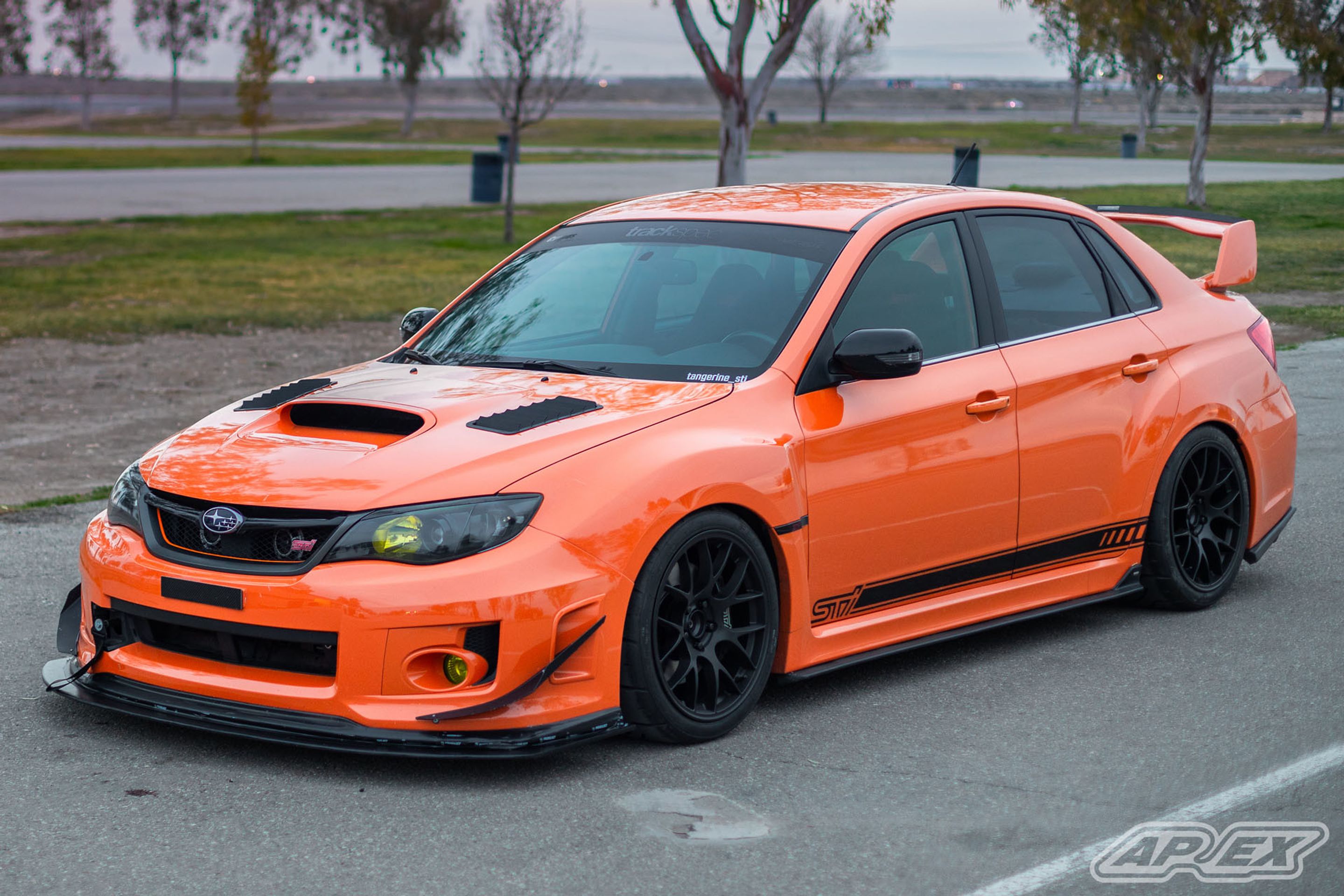 Orange Subaru GR WRX STI with 18" EC-7 Apex wheels in Satin Black