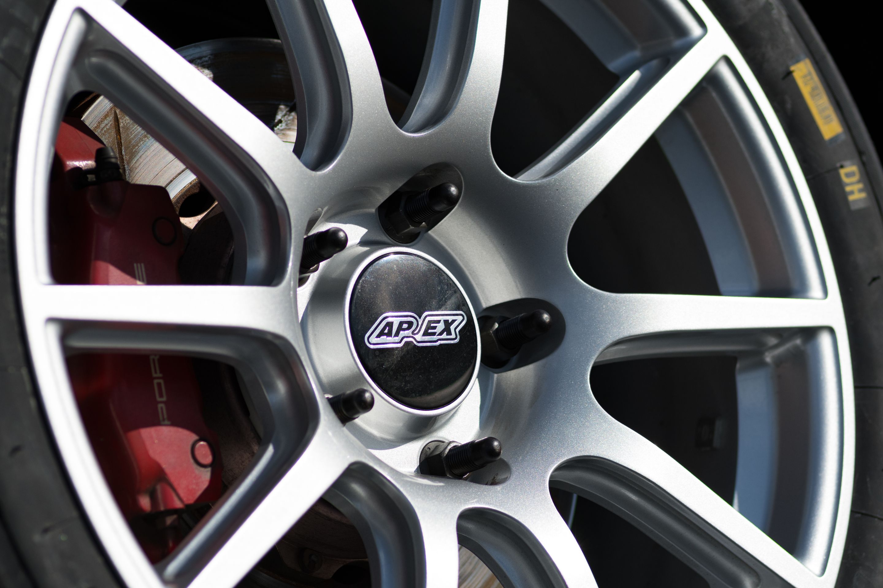 Black Porsche 987 Cayman S with 18" SM-10 Apex wheels in Race Silver