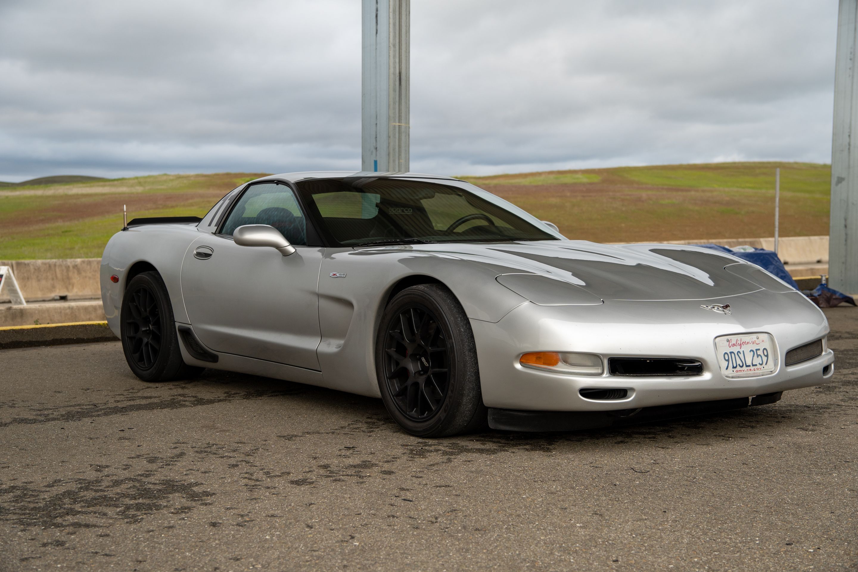 Silver Chevrolet C5 Corvette Z06 with 18" EC-7 Apex wheels in Satin Black