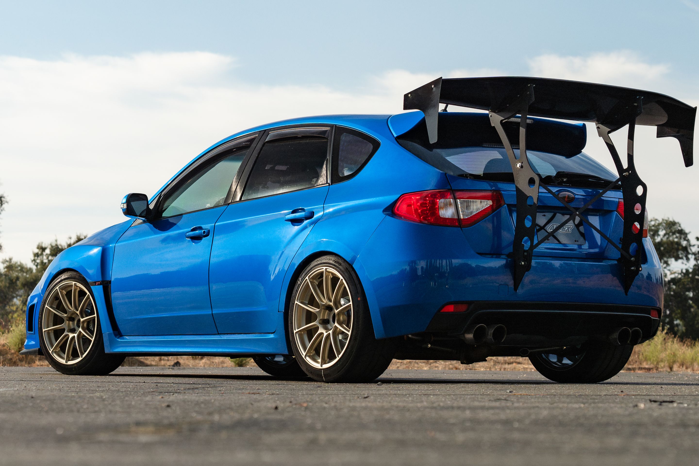 Blue Subaru GR WRX STI with 18" SM-10RS Apex wheels in Motorsport Gold
