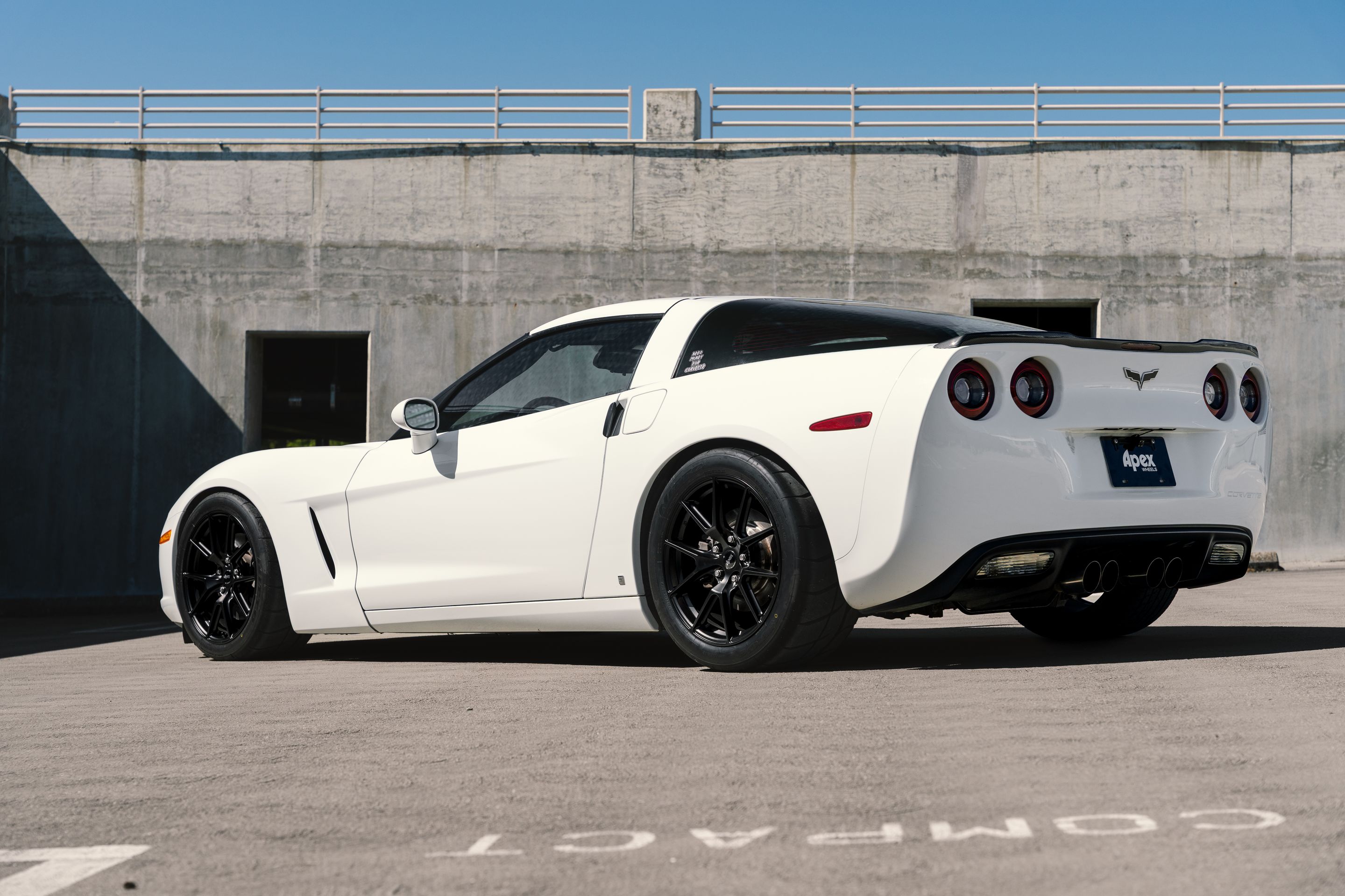 White Chevrolet C6 Corvette Base/Z51 with 18" VS-5 Apex wheels in Satin Black