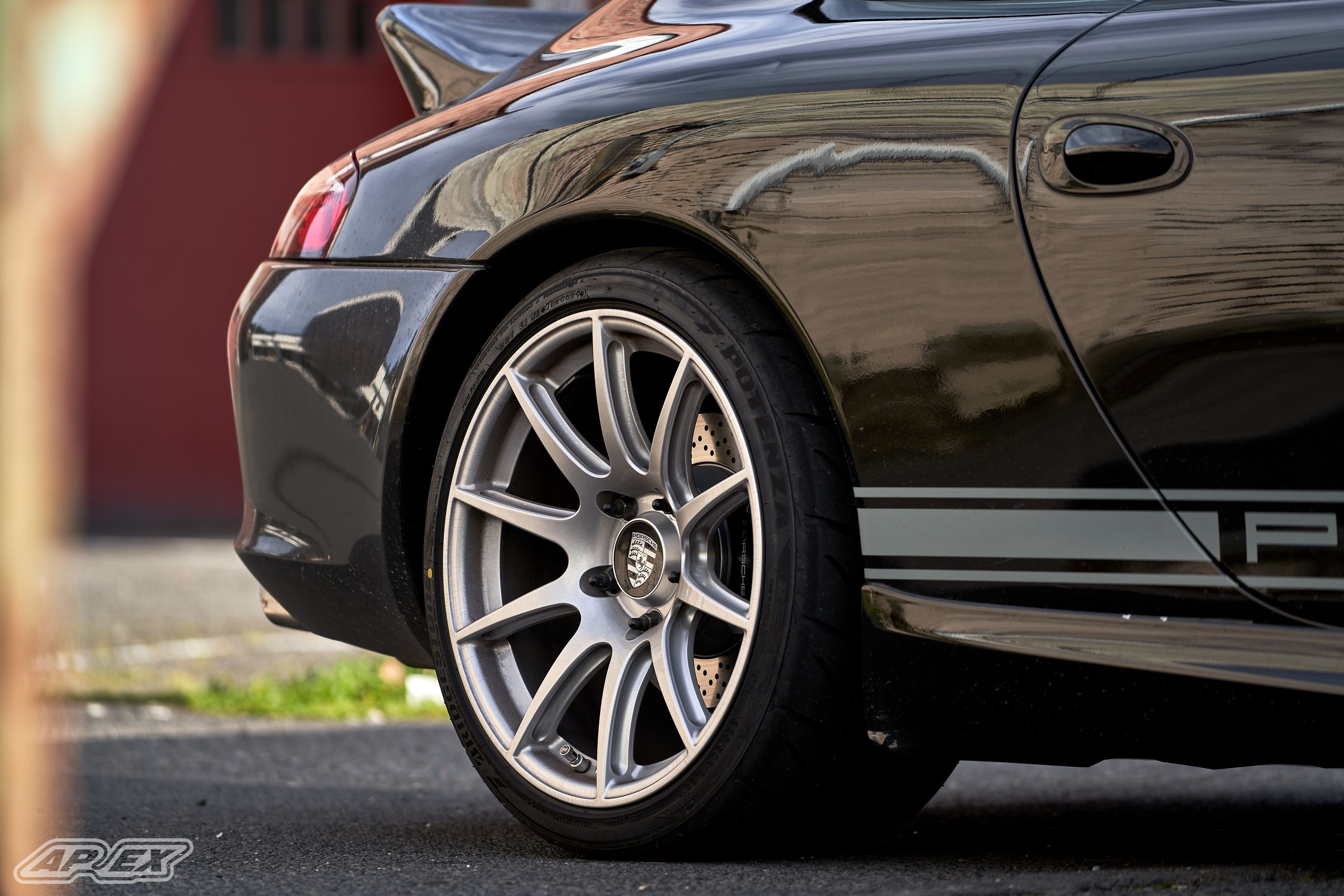 Black Porsche 911 996 Carrera with 18" SM-10 Apex wheels in Race Silver